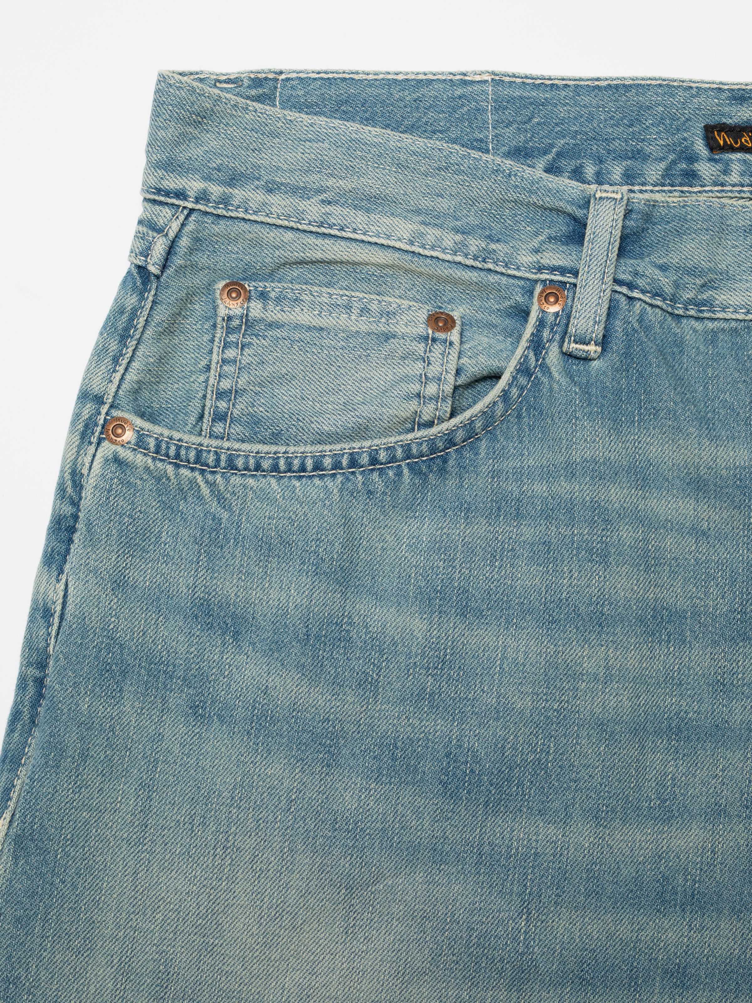 Nudie Jeans Tuff Tony Drift Wood, men's loose fit jeans, close-up of the front pocket and copper rivets.