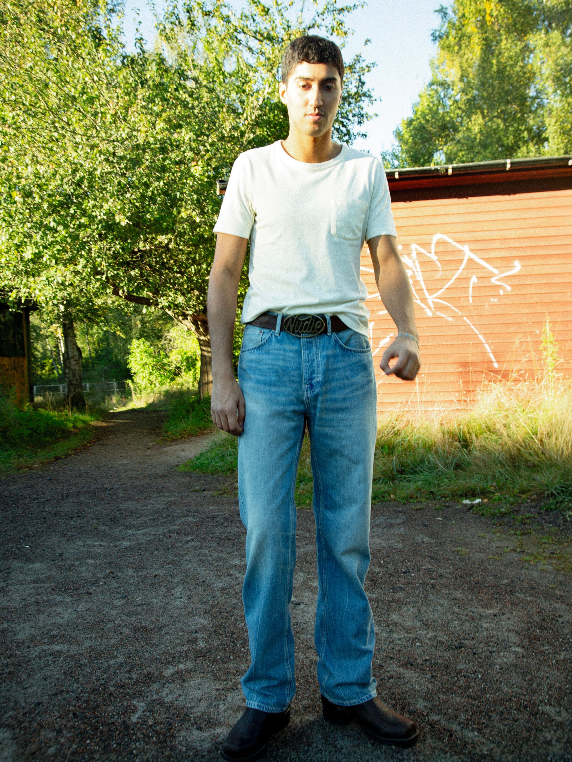 Nudie Jeans Tuff Tony Drift Wood, men's loose fit jeans in light blue, shown from the front on a model.