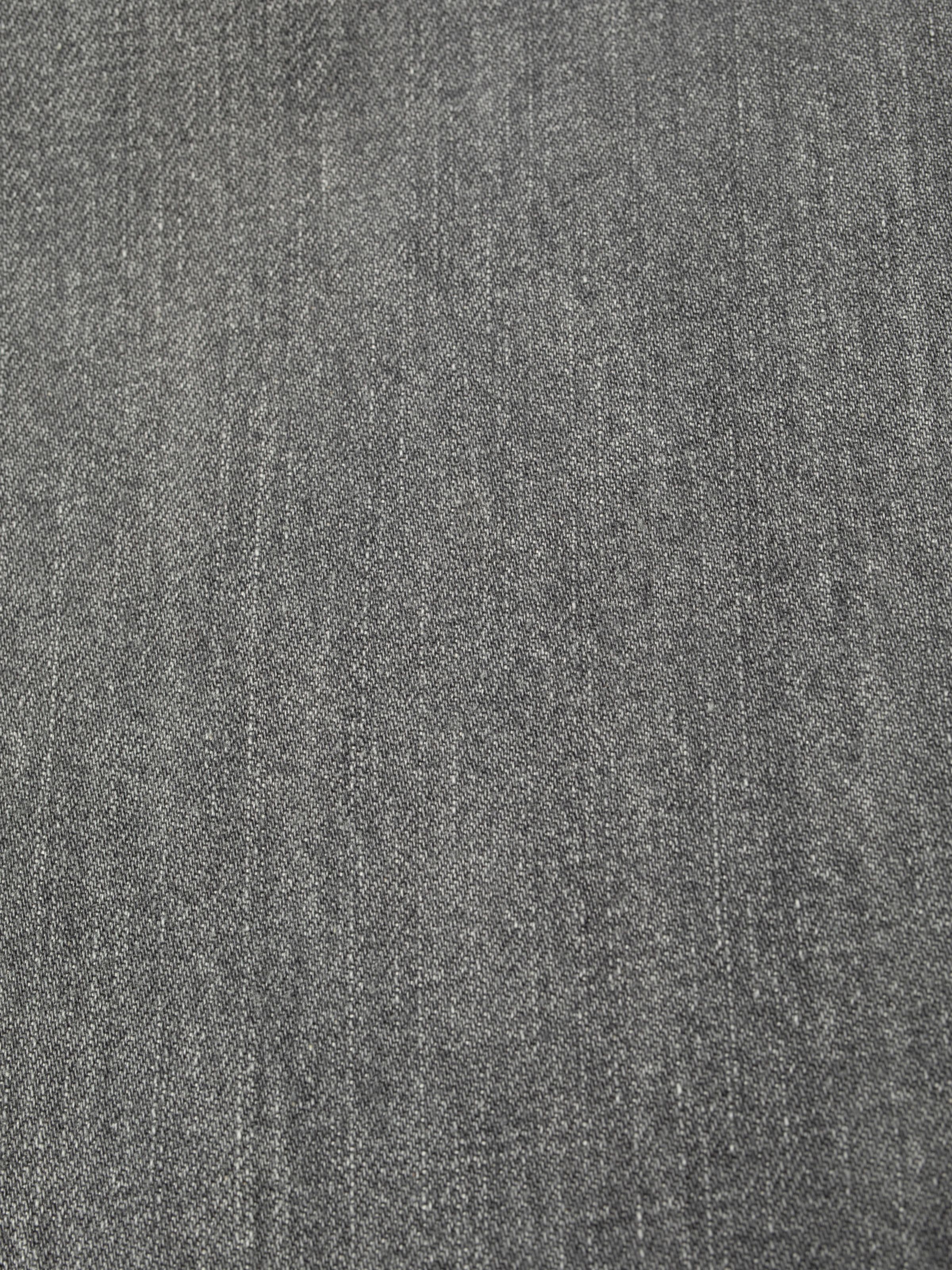 Nudie Jeans Clean Eileen Foggy Grey, a close-up of the 13 oz. rigid denim fabric showing the texture and grey wash.