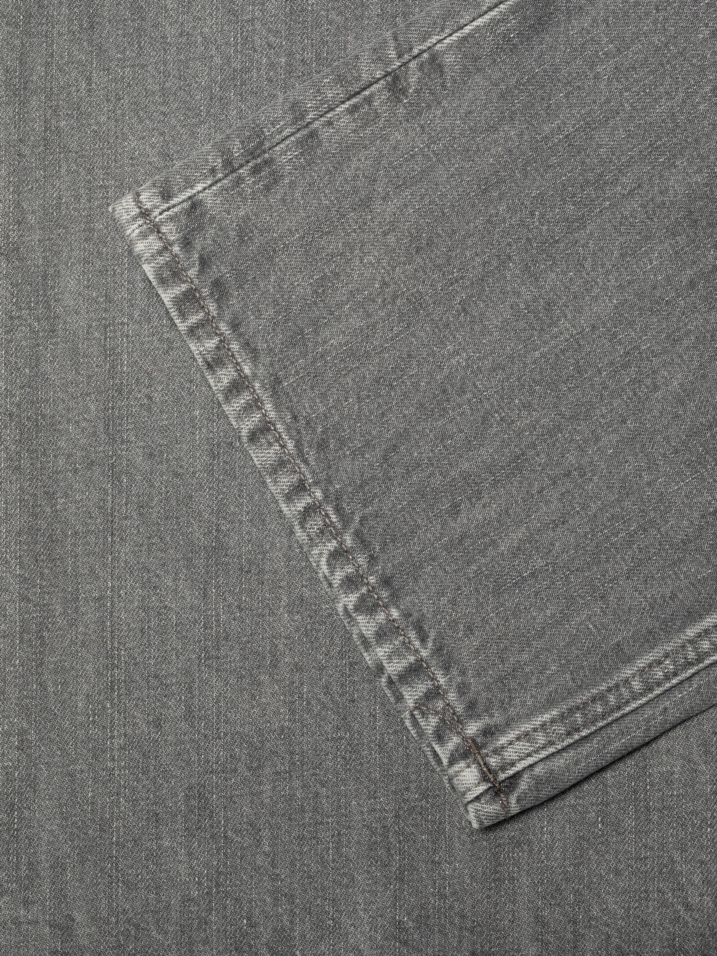 Nudie Jeans Clean Eileen Foggy Grey, close-up of the wide leg opening showing grey stitching and textured denim.
