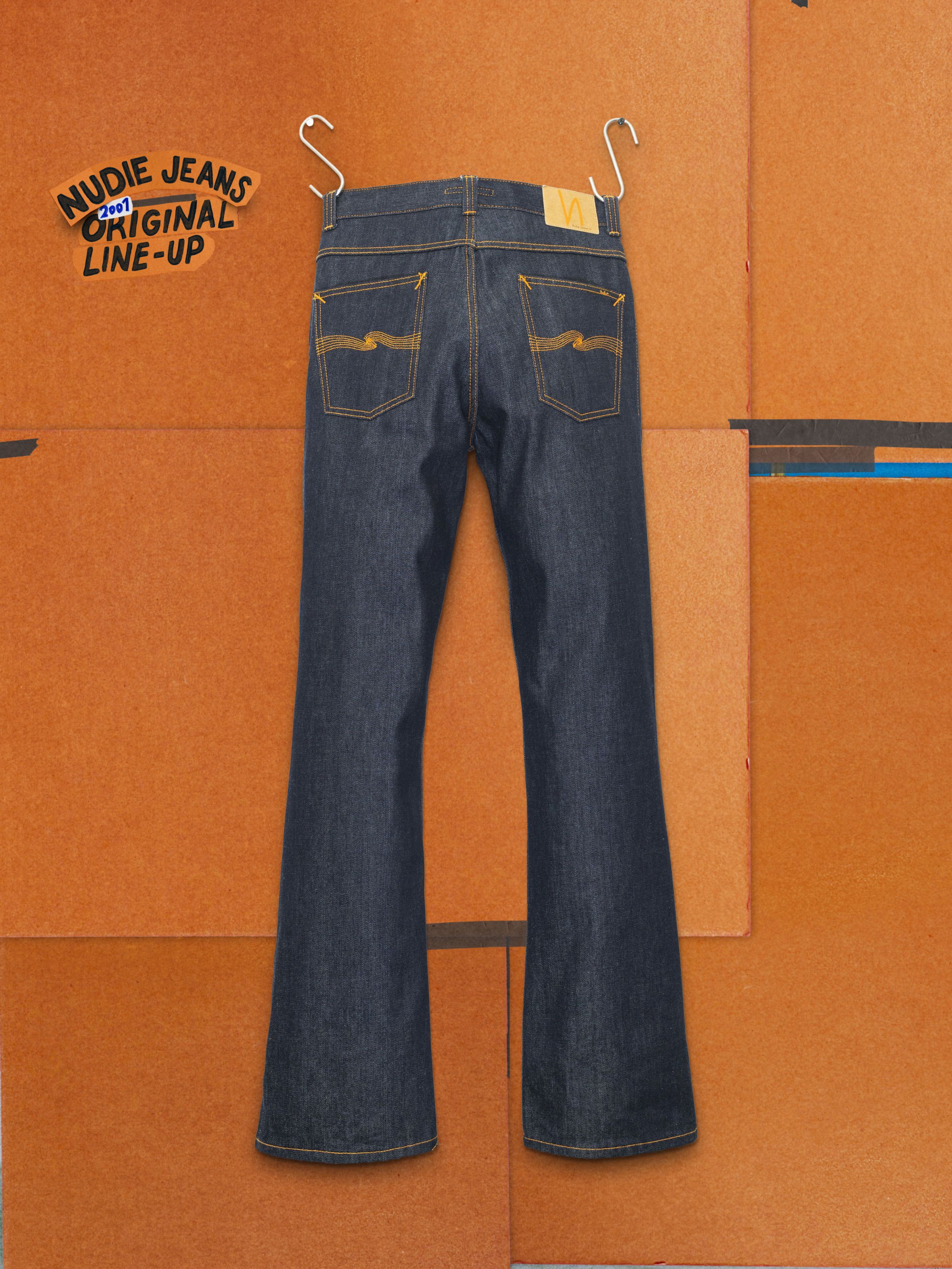 Nudie Jeans Flare Glenn Dry One, regular fit flared jeans in dry blue rigid denim with orange stitching, shown from the back.