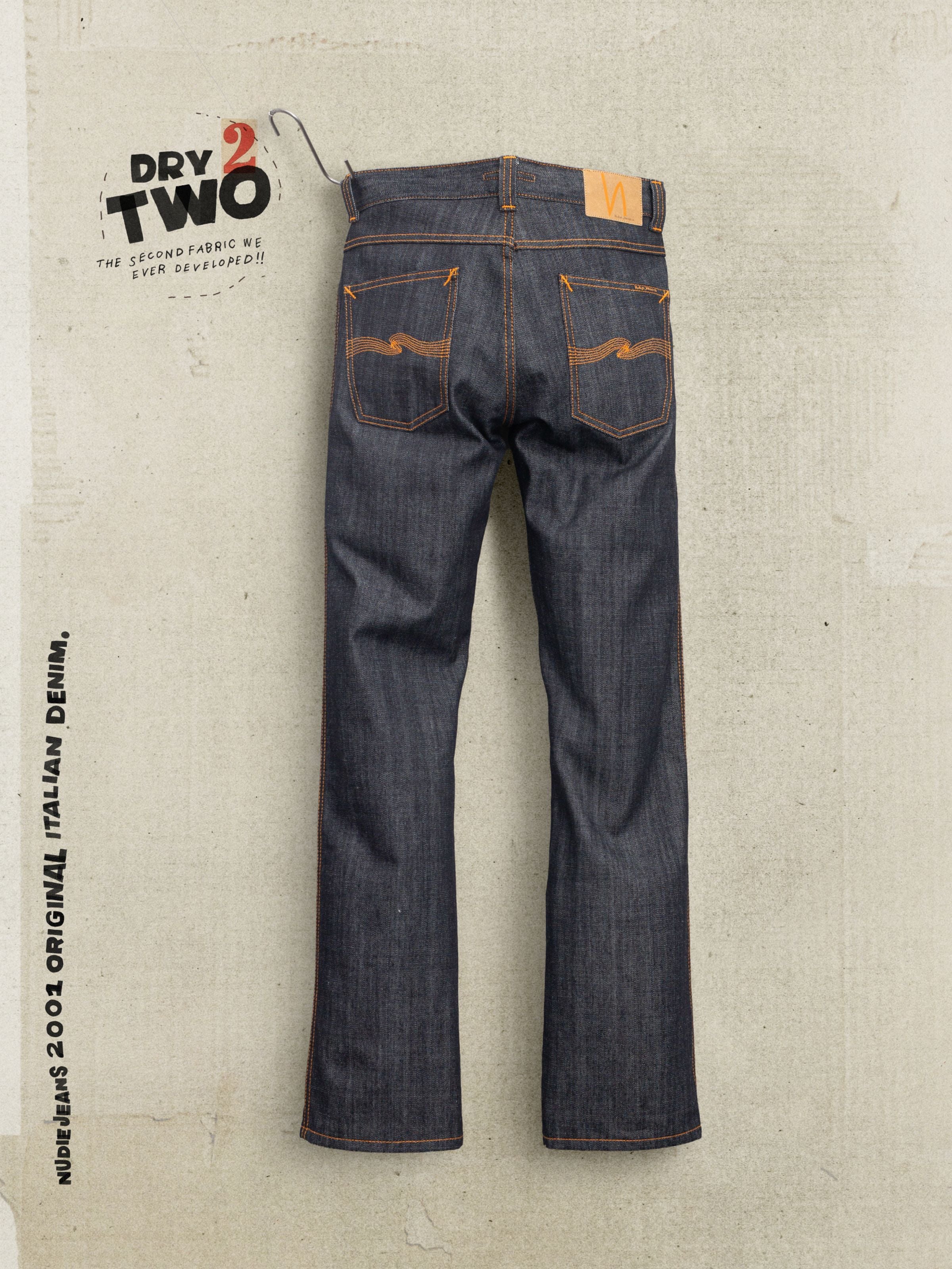 Nudie Jeans Slim Jim Dry Two, slim straight jeans in blue rigid organic cotton denim, back view with orange embroidery.