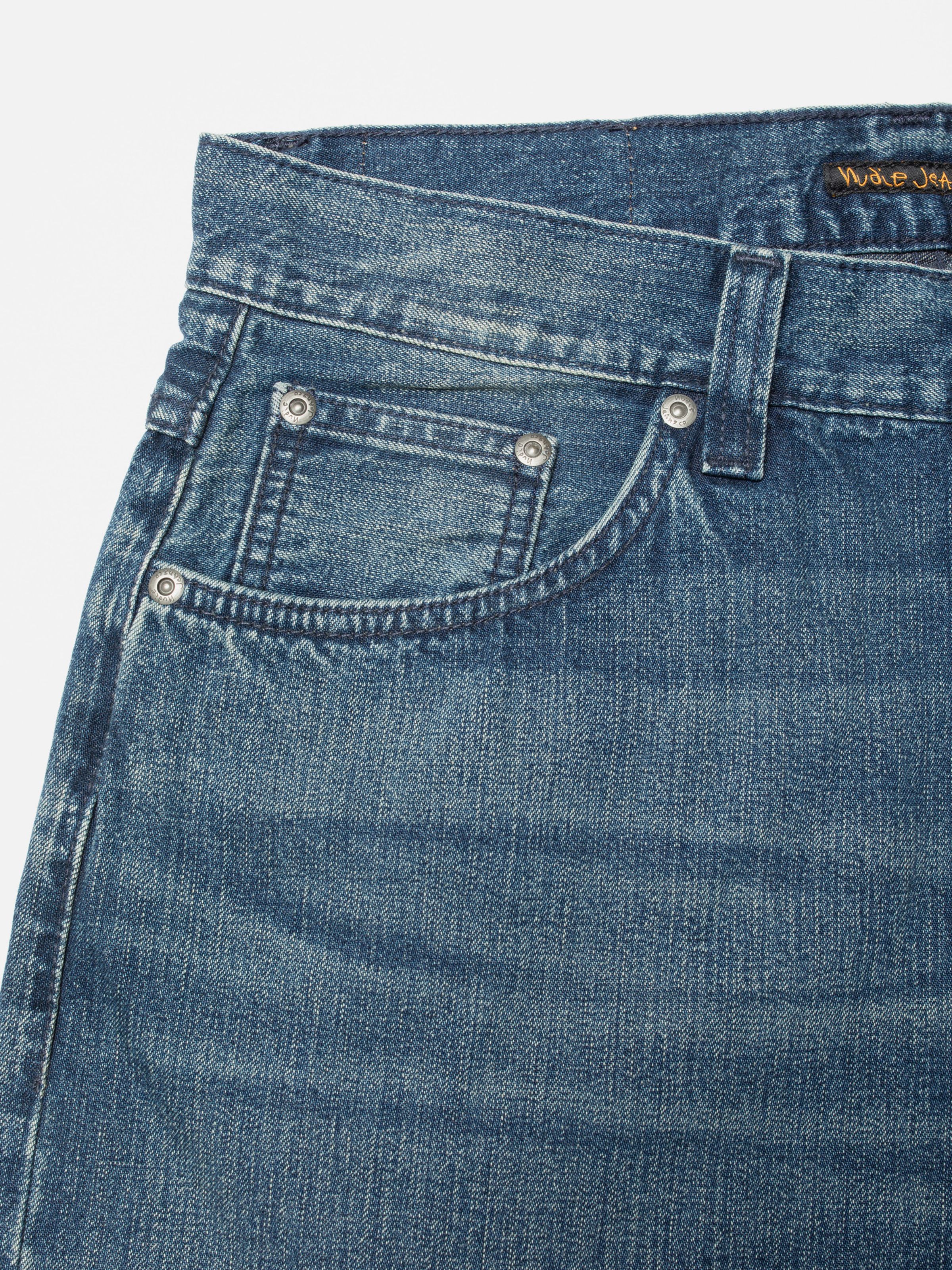 Nudie Jeans Loud Larry Blue Painter, a close-up of the front pocket and antique silver trims on the blue denim.