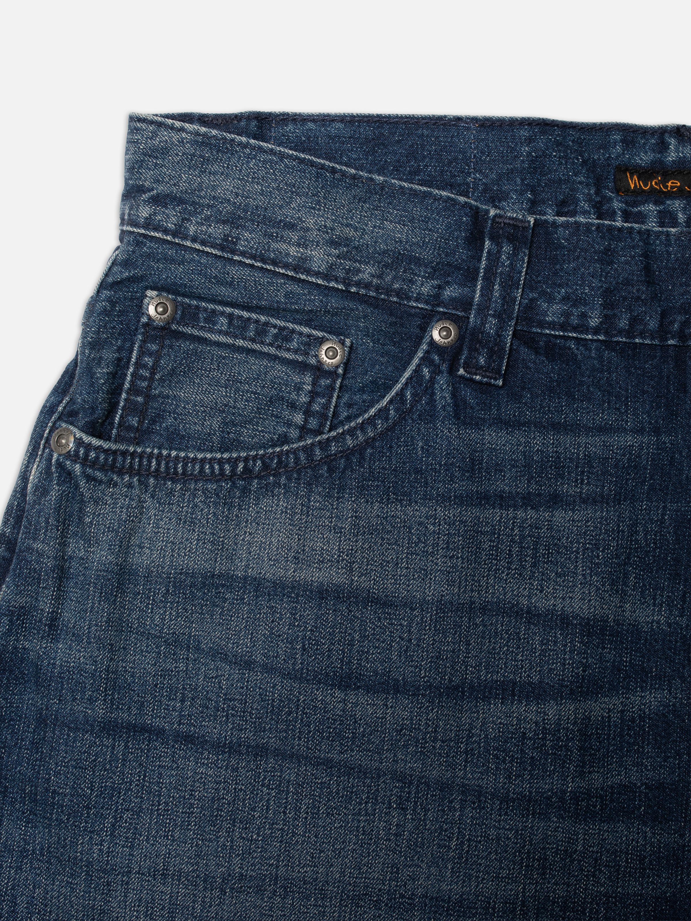Nudie Jeans Zeb Denim Shorts Blue Painter, close-up of the front pocket showing the textured blue denim and rivets.
