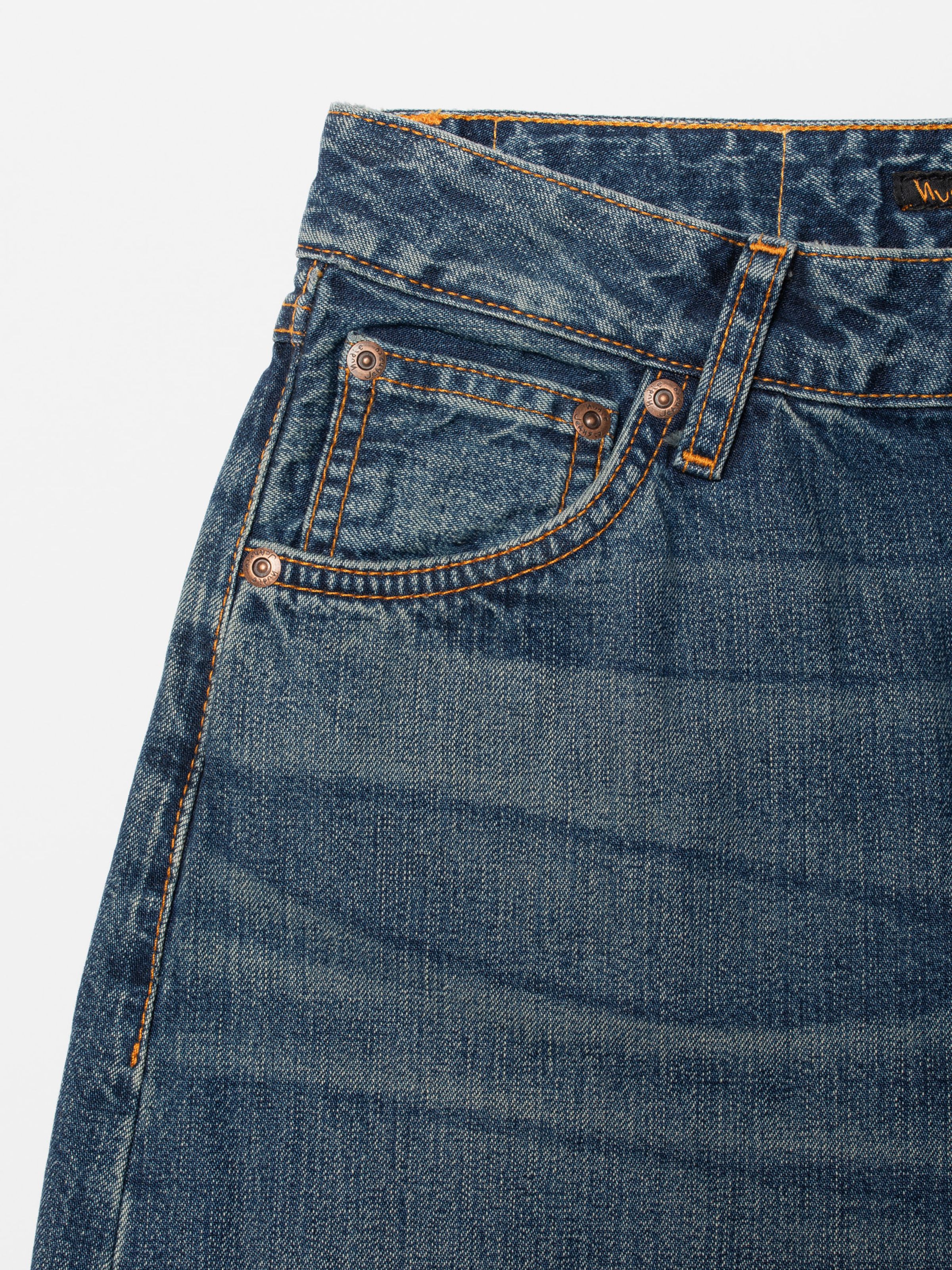 Nudie Jeans Sonic Sue Orange Painter, close-up of the front pocket showing orange stitching and copper rivets.