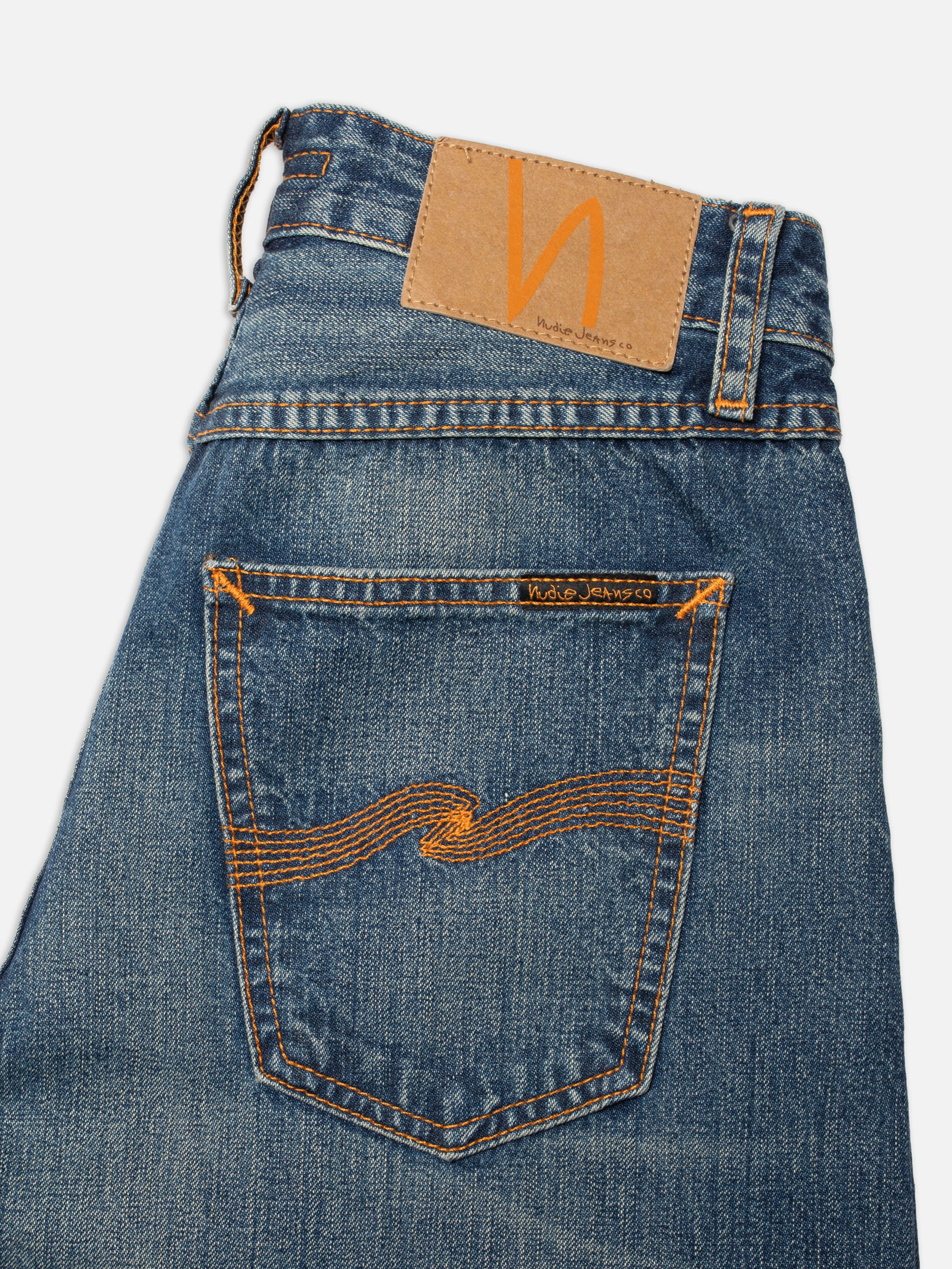Nudie Jeans Sonic Sue Orange Painter, close-up of the back pocket with orange embroidery and Jacron patch.
