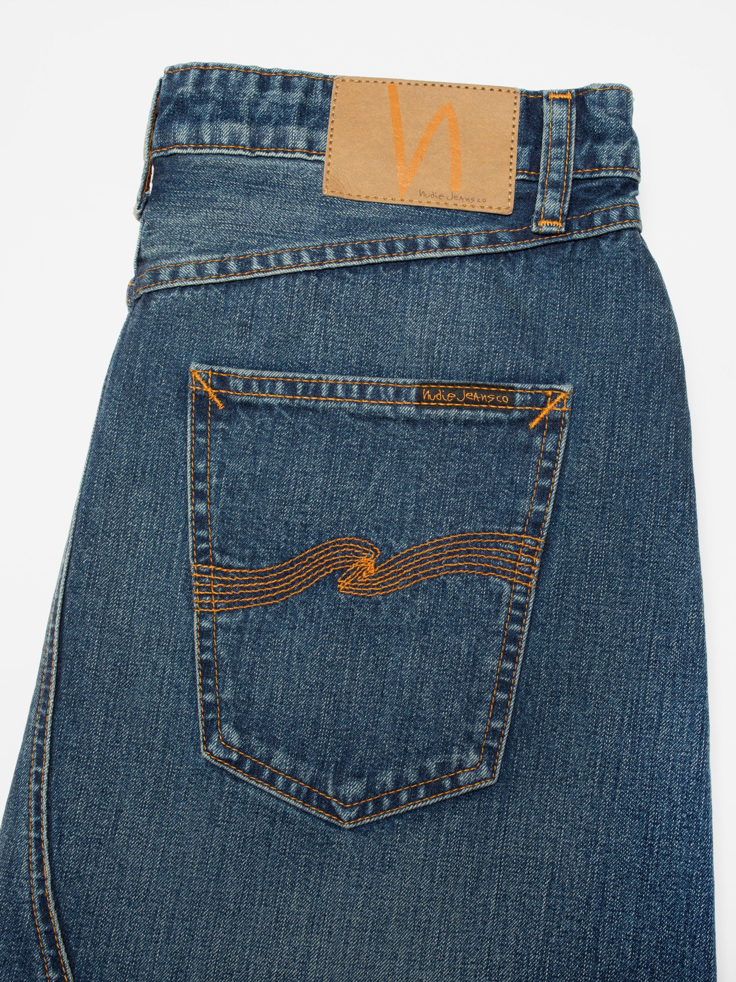 Nudie Jeans Tanja Skirt Orange Painter, close-up of the back pocket with orange embroidery and Jacron patch.