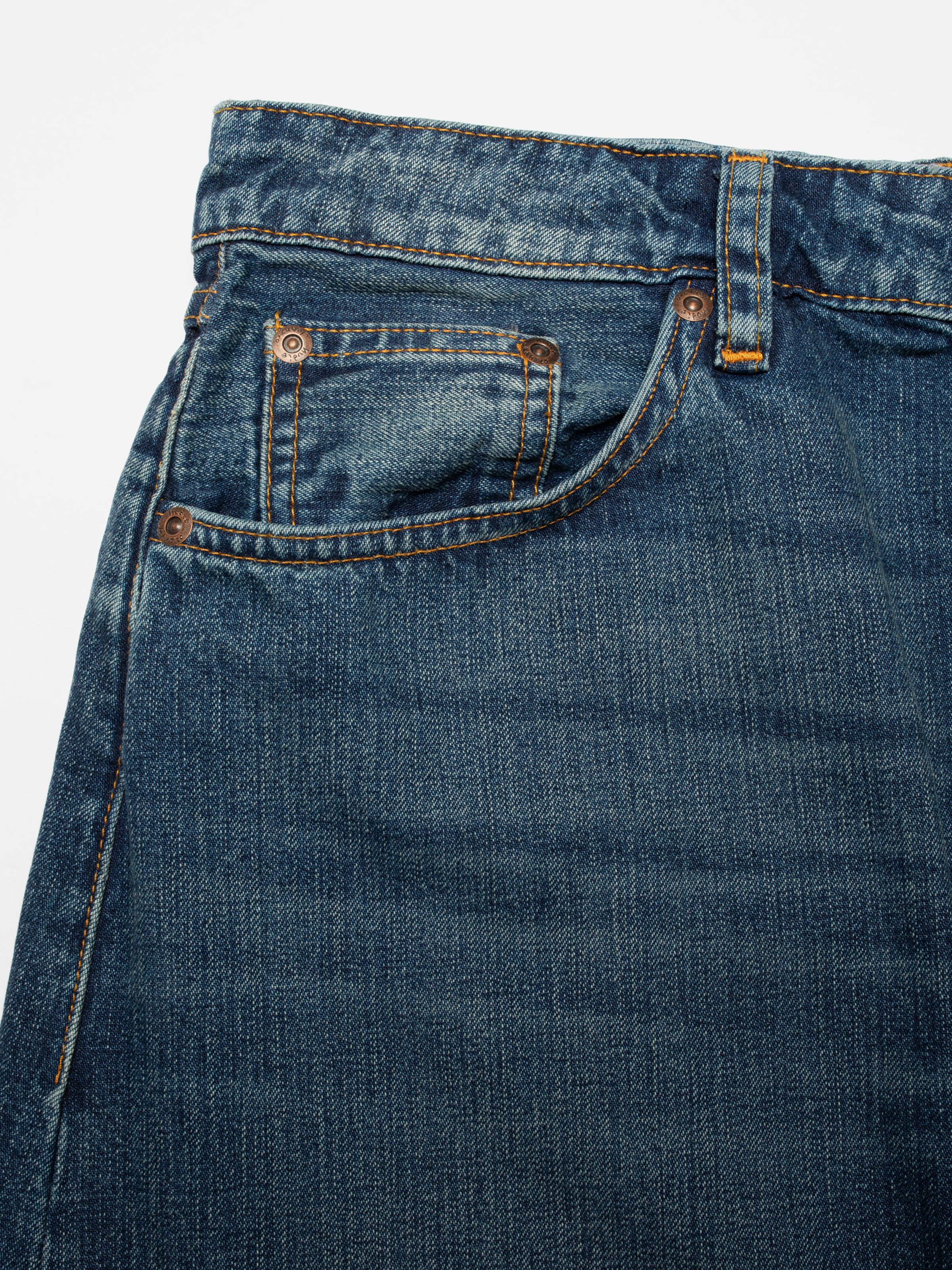 Nudie Jeans Tanja Skirt Orange Painter, close-up of the front pocket showing orange stitching and copper rivets.