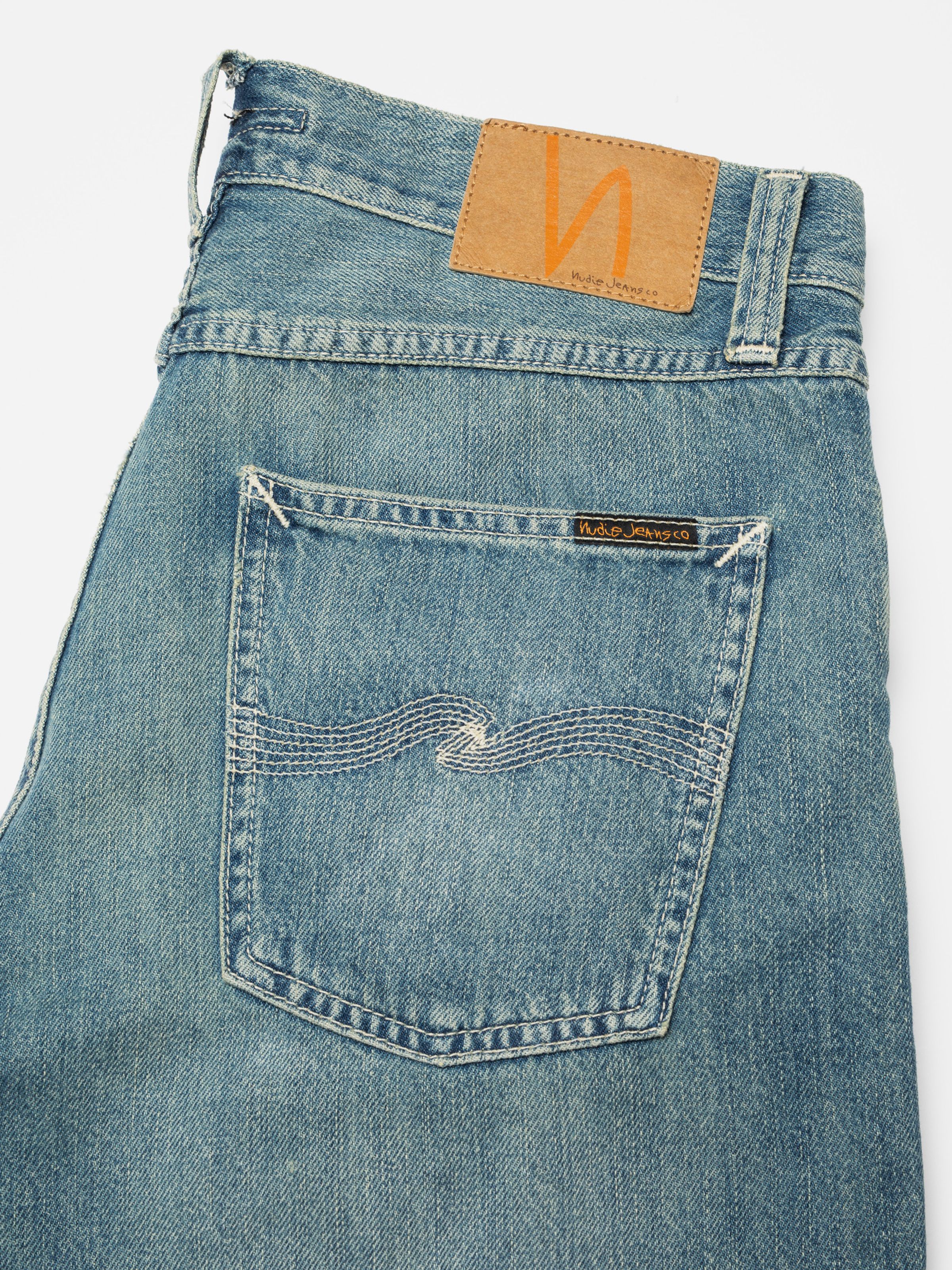 Nudie Jeans Seth Denim Shorts Drift Wood, close-up of the back pocket showing the ecru embroidery and jacron patch.