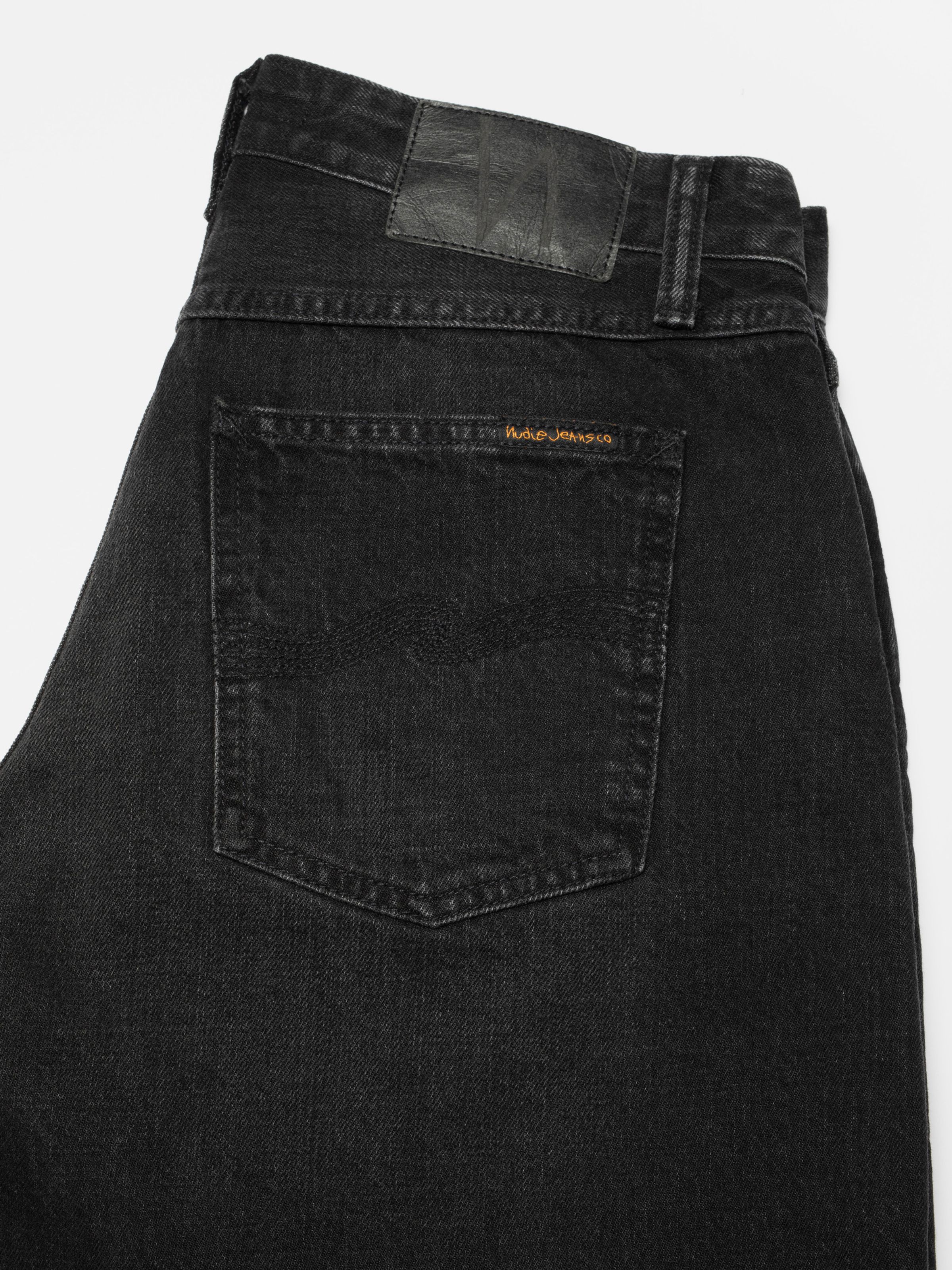 Nudie Jeans Meja Denim Shorts Night Dune, close-up of the back pocket and Jacron patch against a white background.