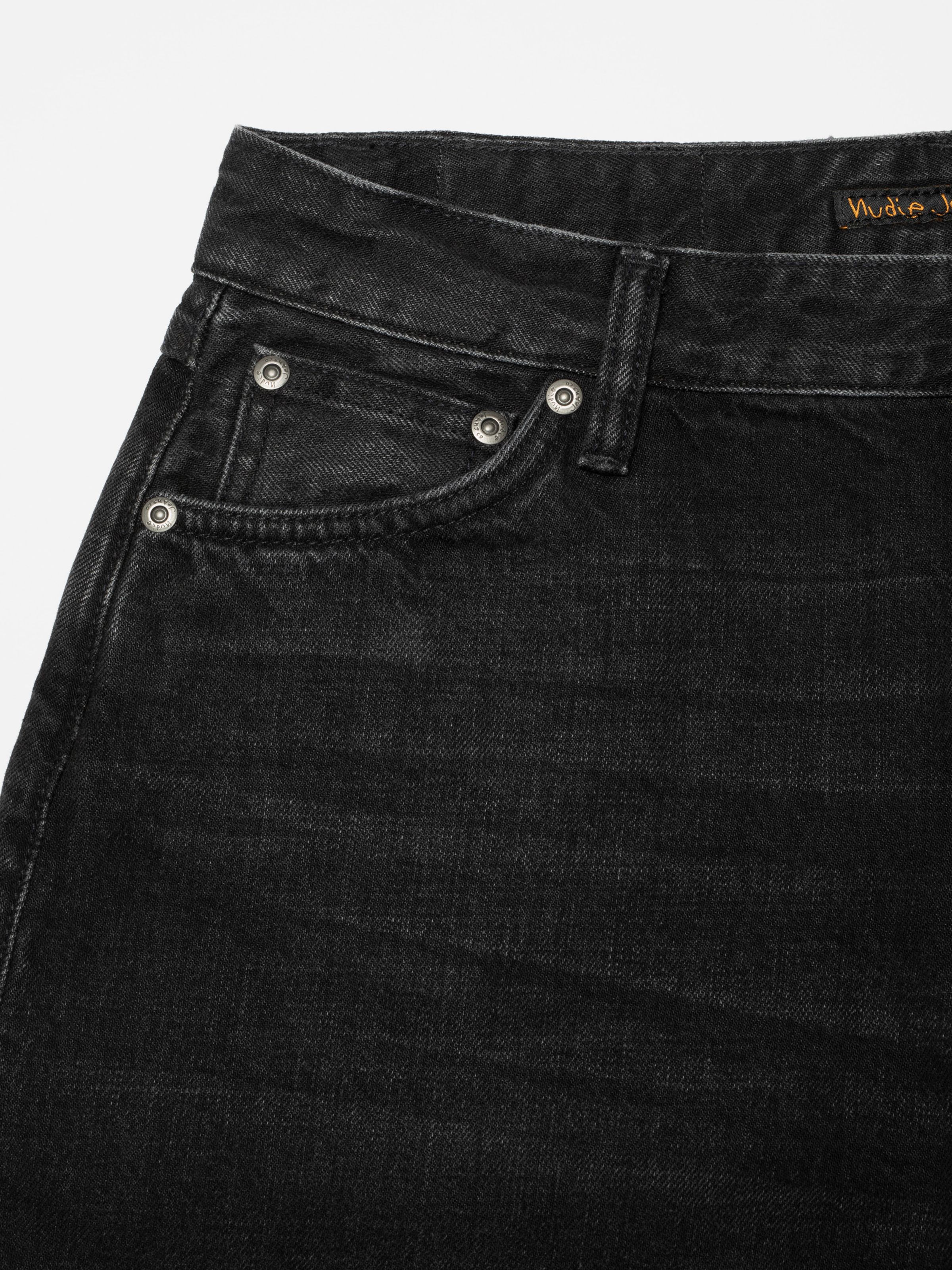 Nudie Jeans Meja Denim Shorts Night Dune, close-up of the front pocket and silver-toned rivets on black denim.