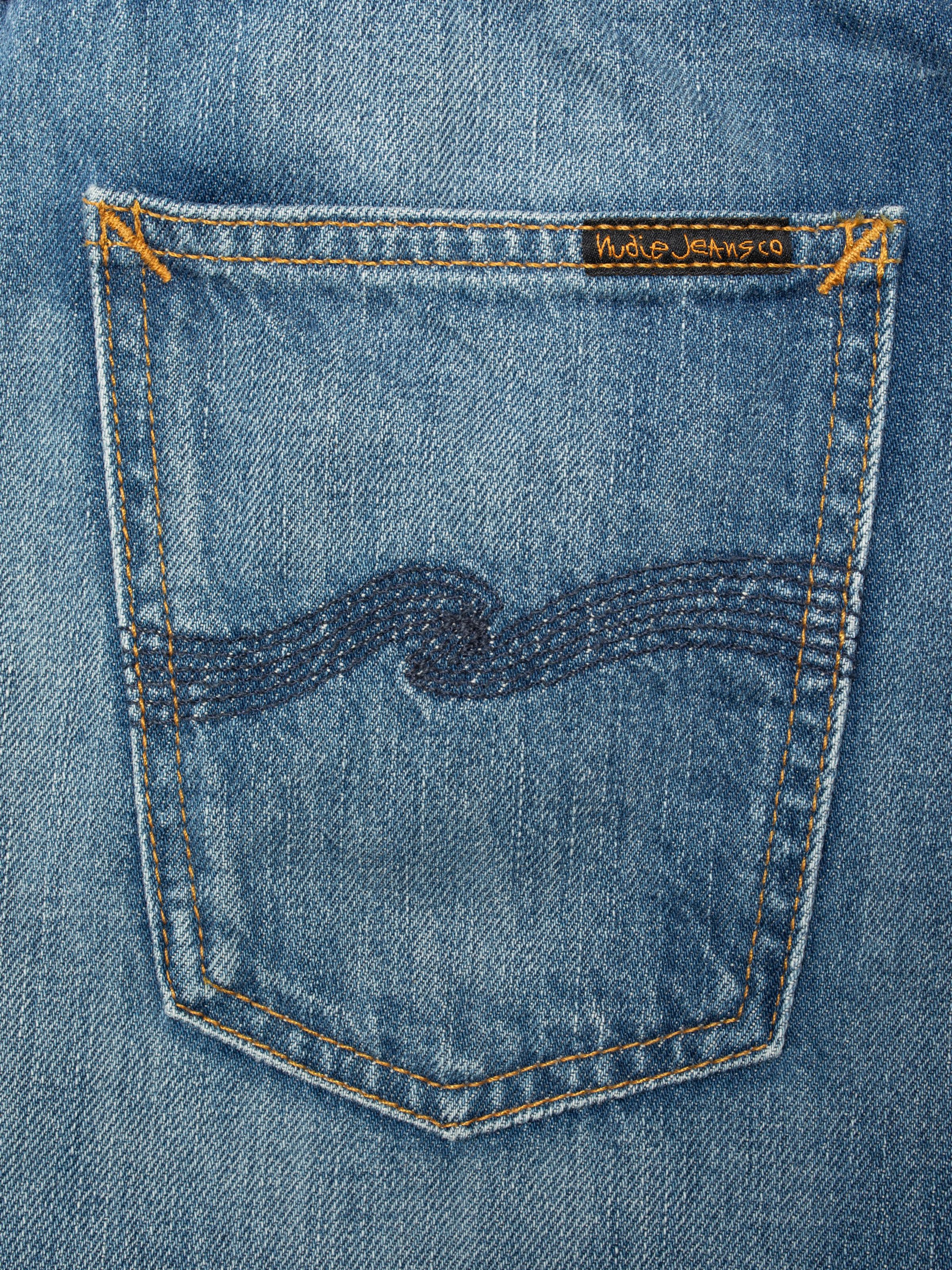 Nudie Jeans Maeve Denim Shorts Clear Skies, close-up of the back pocket showing the navy embroidery and brand label.