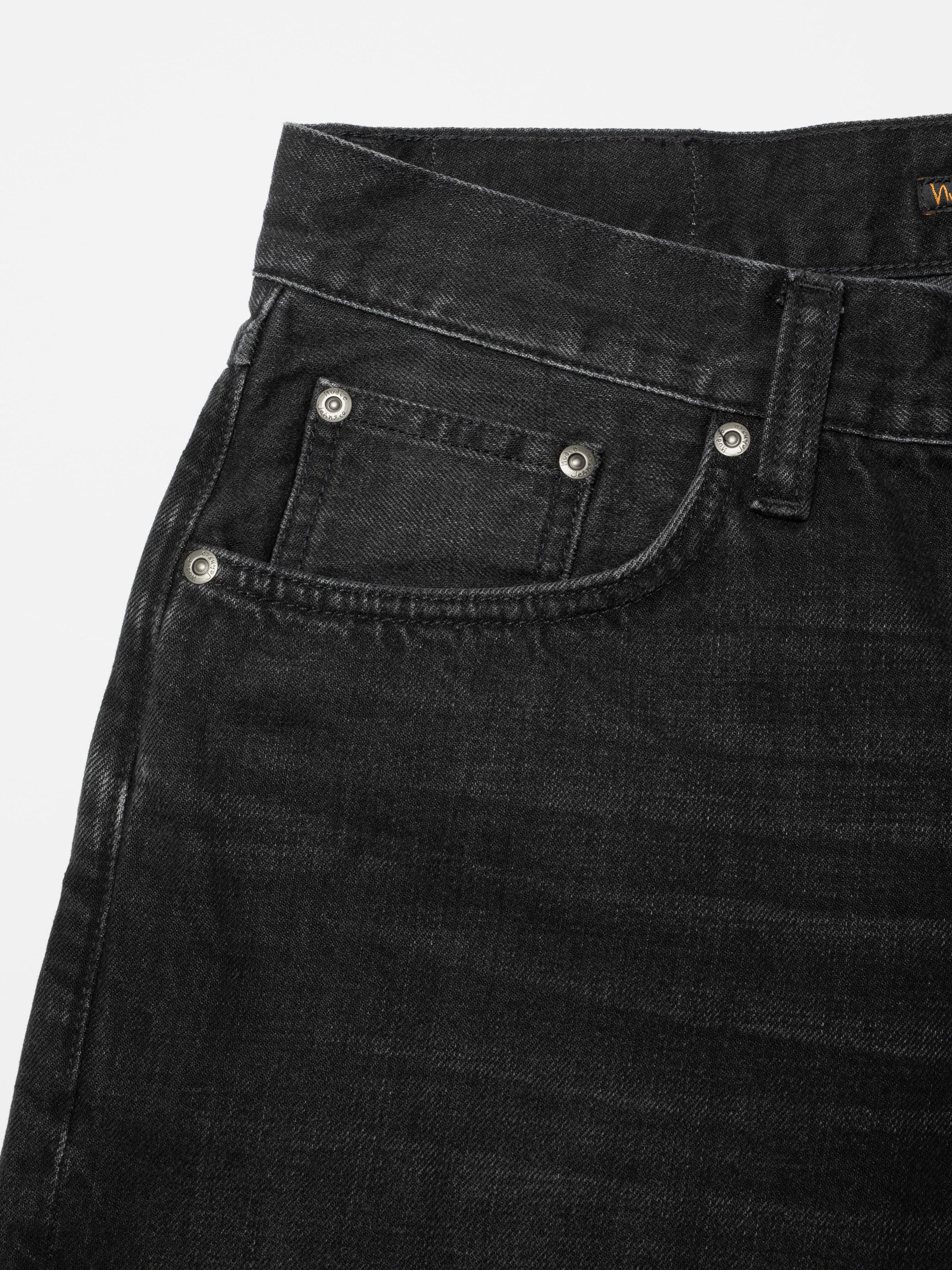 Nudie Jeans Seth Denim Shorts Night Dune, close-up of the front pocket and waistband showing antique silver trims.