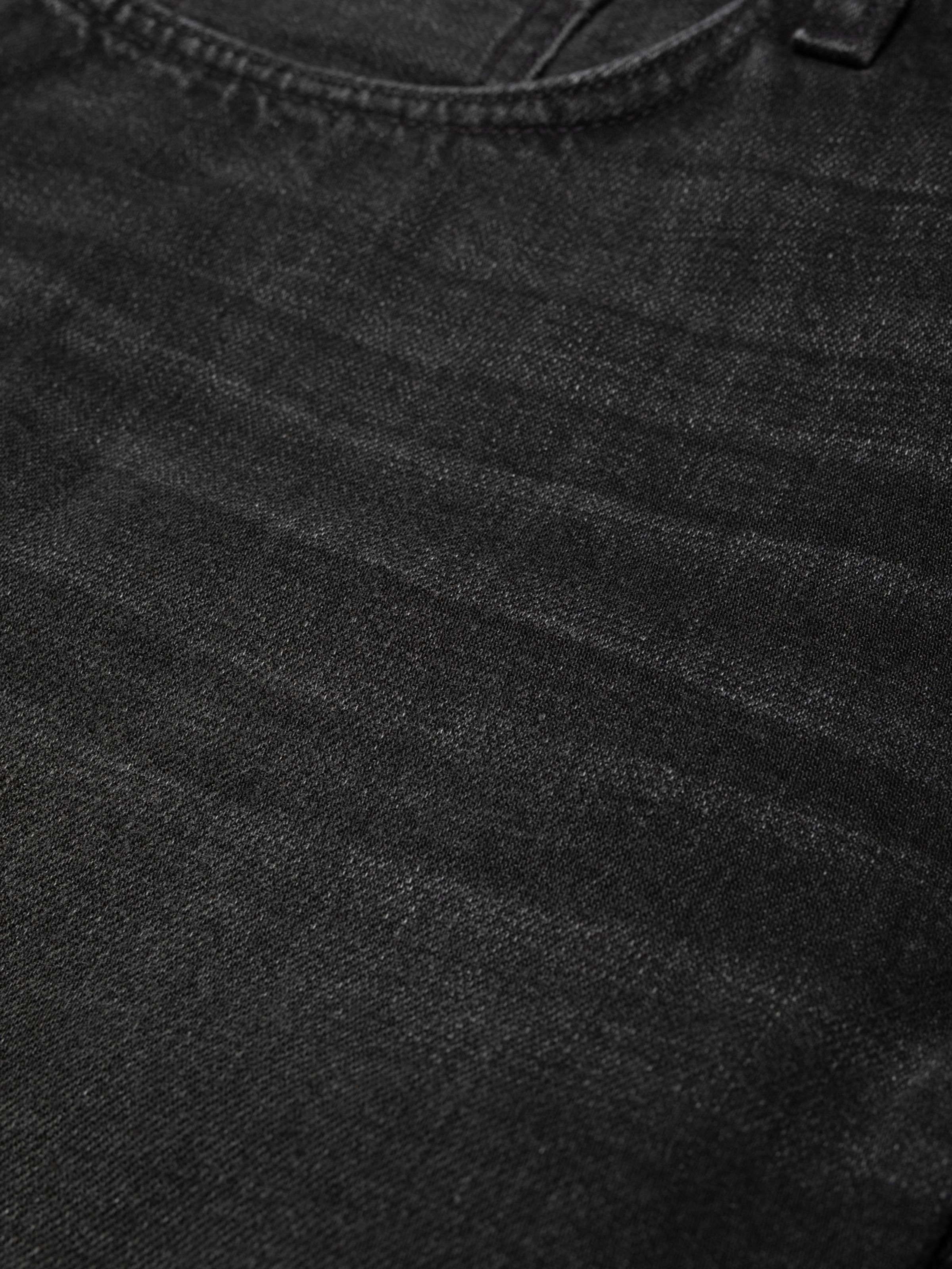 Nudie Jeans Seth Denim Shorts Night Dune, close-up of the black denim fabric showing texture and slub.