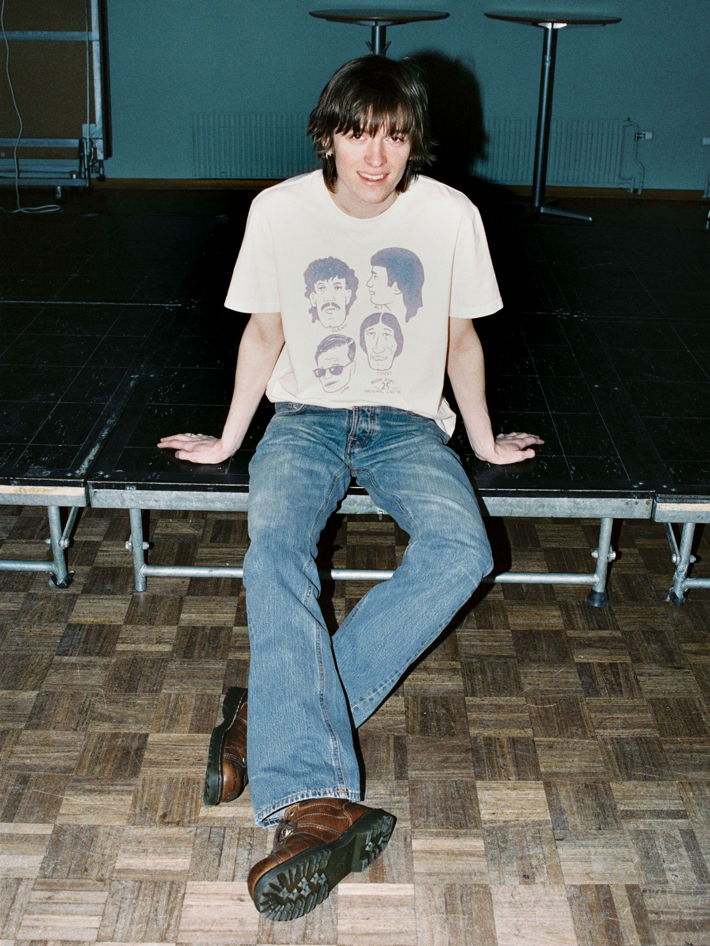 Nudie Jeans Regular Alf Silver Tracks, men's regular fit bootcut jeans shown on a model in a lifestyle setting.