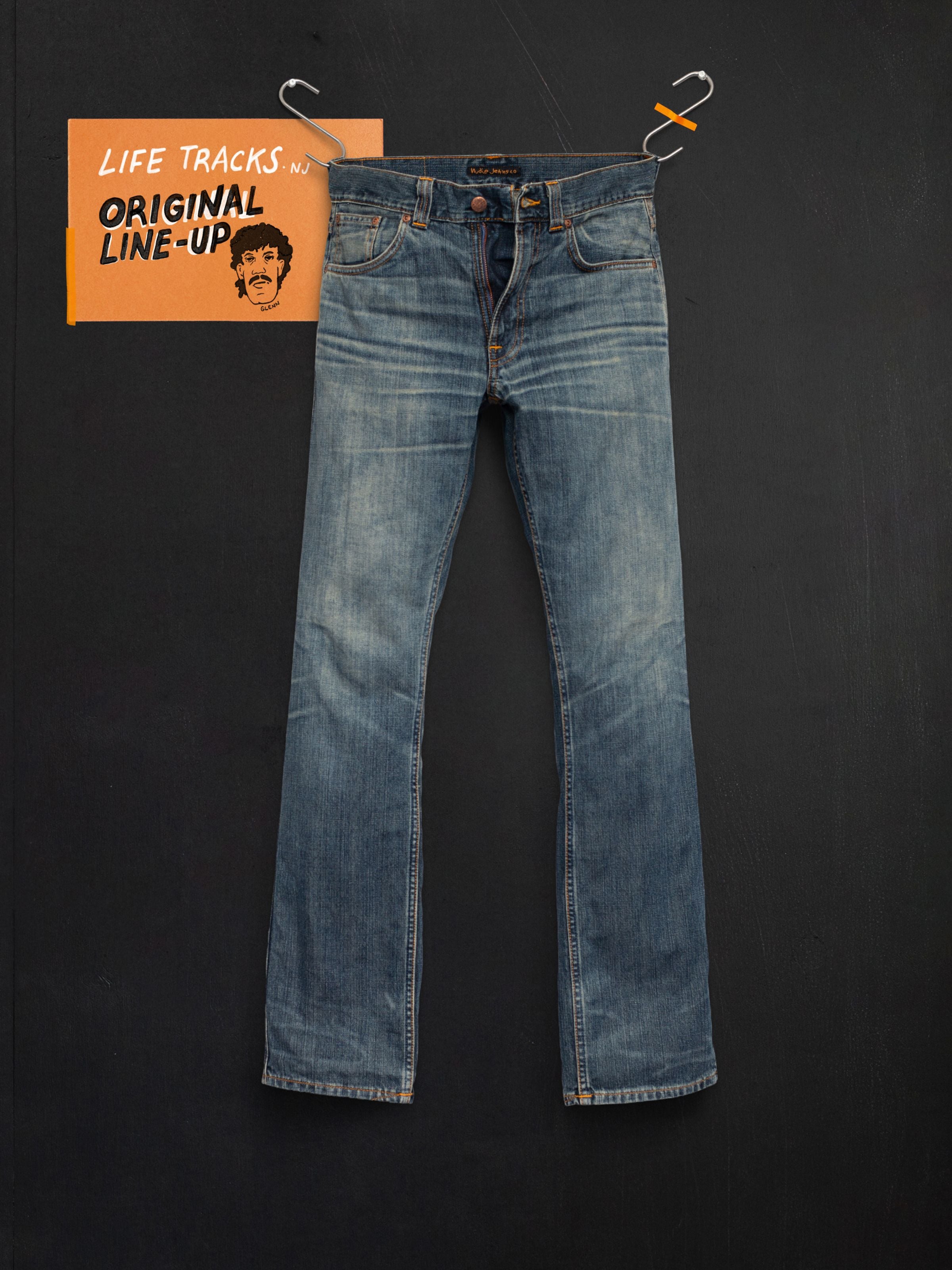 Nudie Jeans Slim Jim Quarter Tracks, slim fit jeans in mid blue washed rigid denim, shown in a front flatshot.