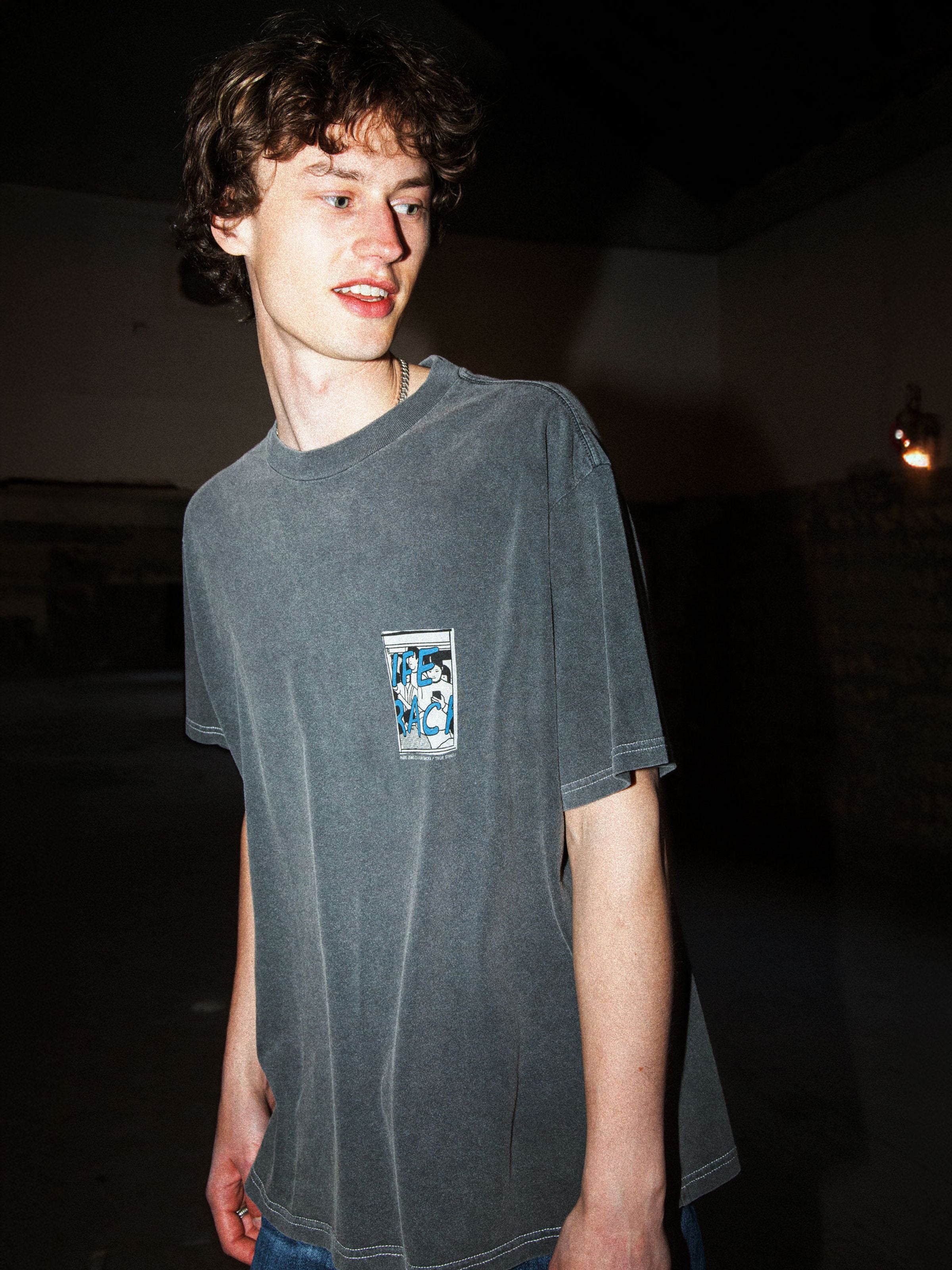 Nudie Jeans Koffe T-Shirt LifeTracks III in Antracite organic cotton, featuring a chest graphic and shown on a model.