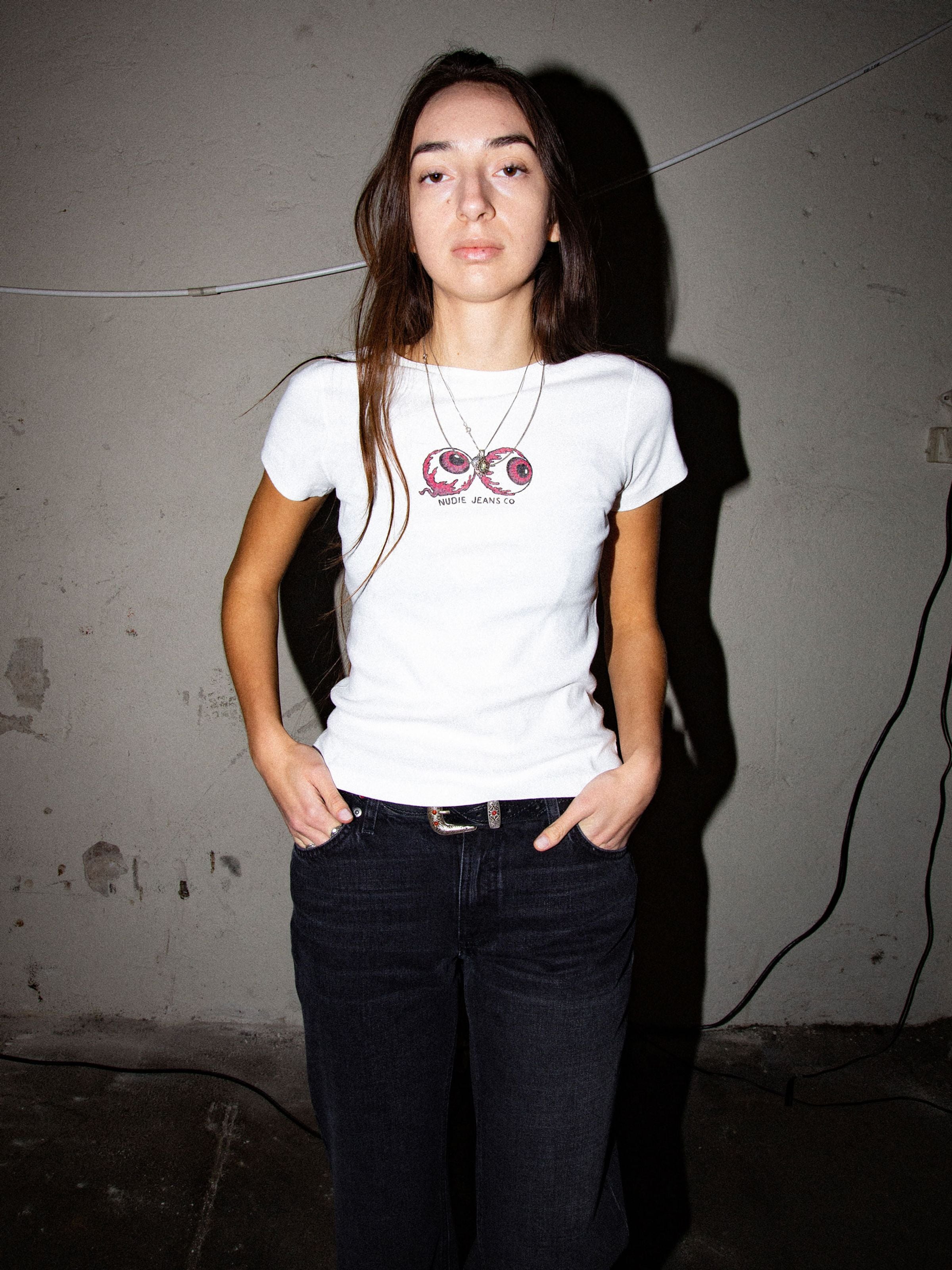 Nudie Jeans Eve T-Shirt Eyeballs Offwhite, a slim fit organic cotton rib t-shirt with chest graphics shown on a model.