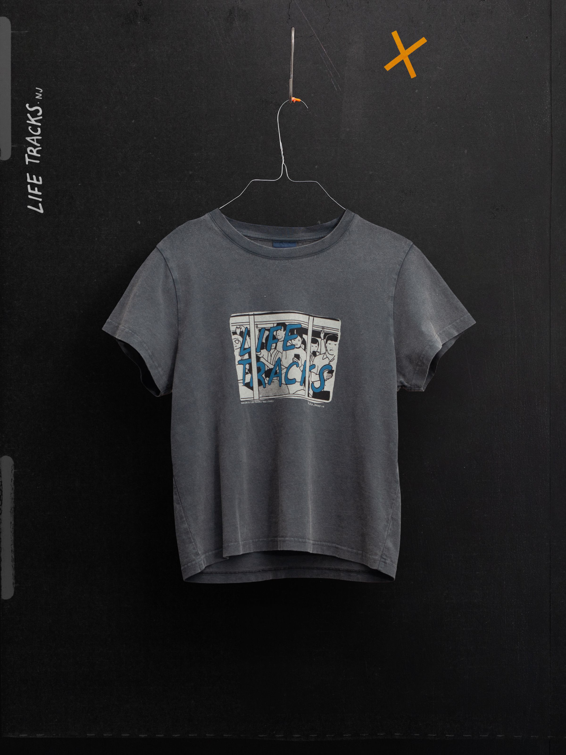 Nudie Jeans Frankie T-Shirt Life Tracks II Antracite, a faded organic cotton crew-neck with a chest print, shown hanging.