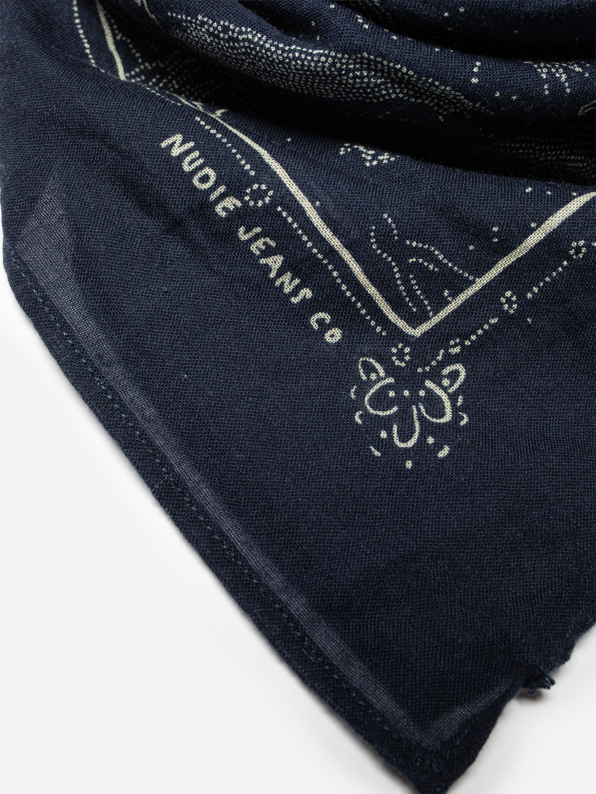 Nudie Jeans Ingrid Bandana Starburst Blue, close-up of the organic cotton fabric with logo and white starburst print.