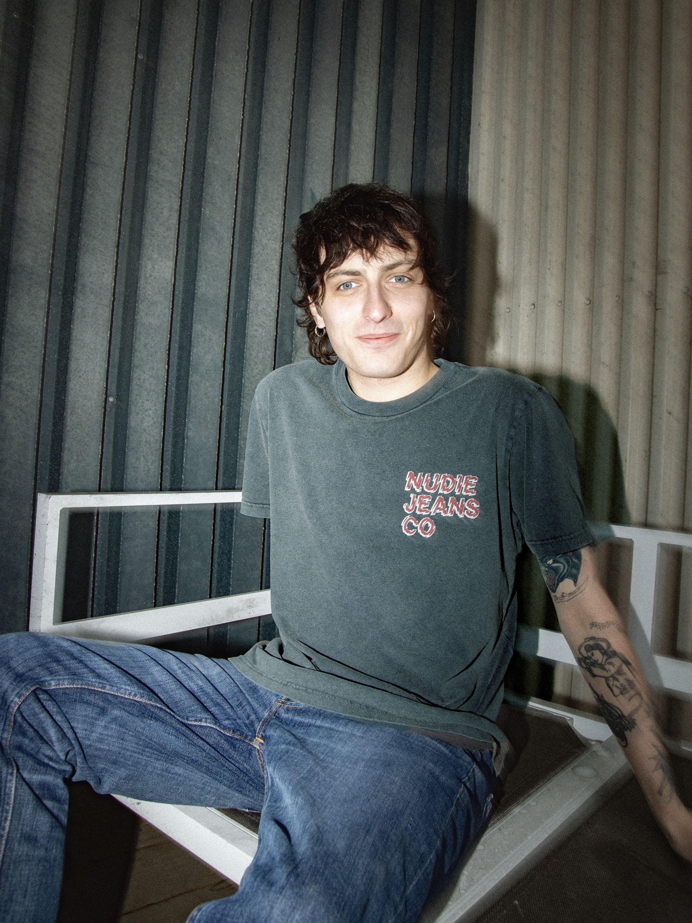 Nudie Jeans Roy T-Shirt Life Tracks I in Antracite, a short-sleeved organic cotton tee with chest print on a model.