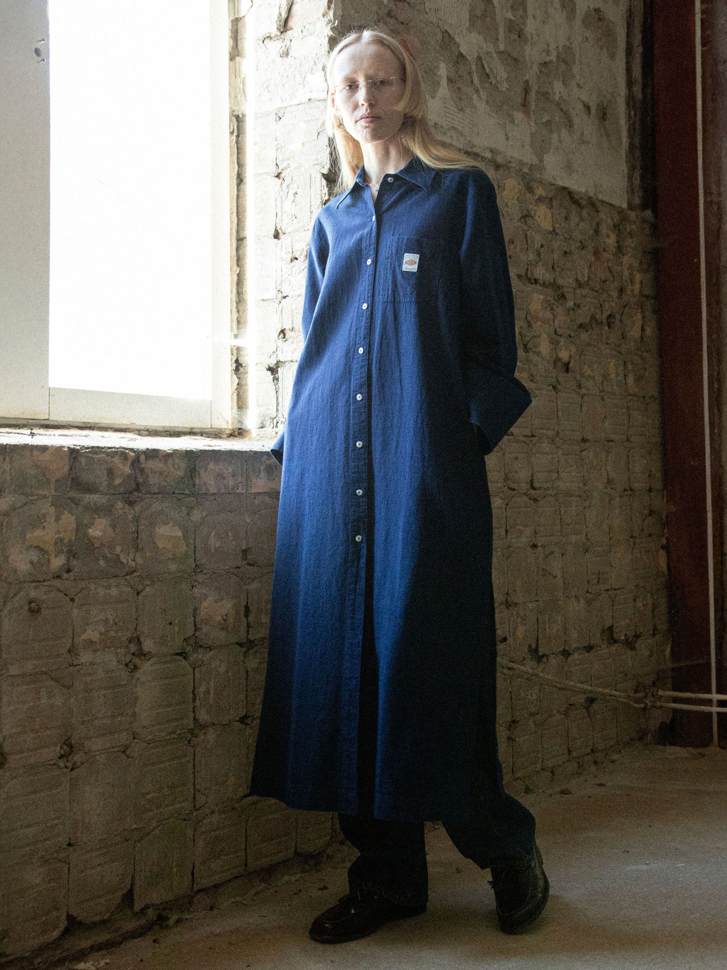 Nudie Jeans Nila Shirt Dress Indigo Blue, a relaxed-fit organic cotton and linen dress shown on a model.