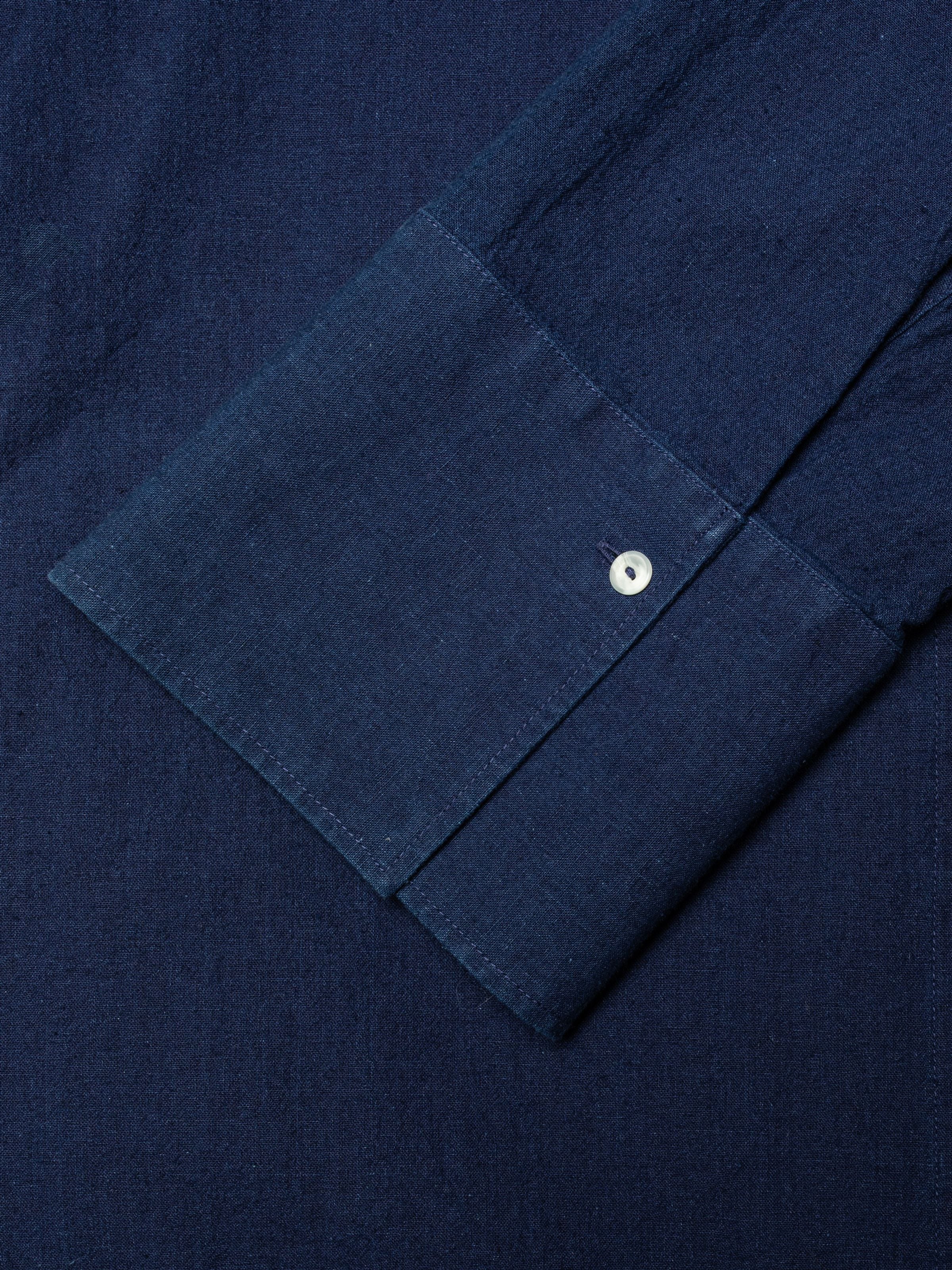 Nudie Jeans Nila Shirt Dress Indigo Blue, close-up of the wide cuff and white corozo button on organic cotton and linen.