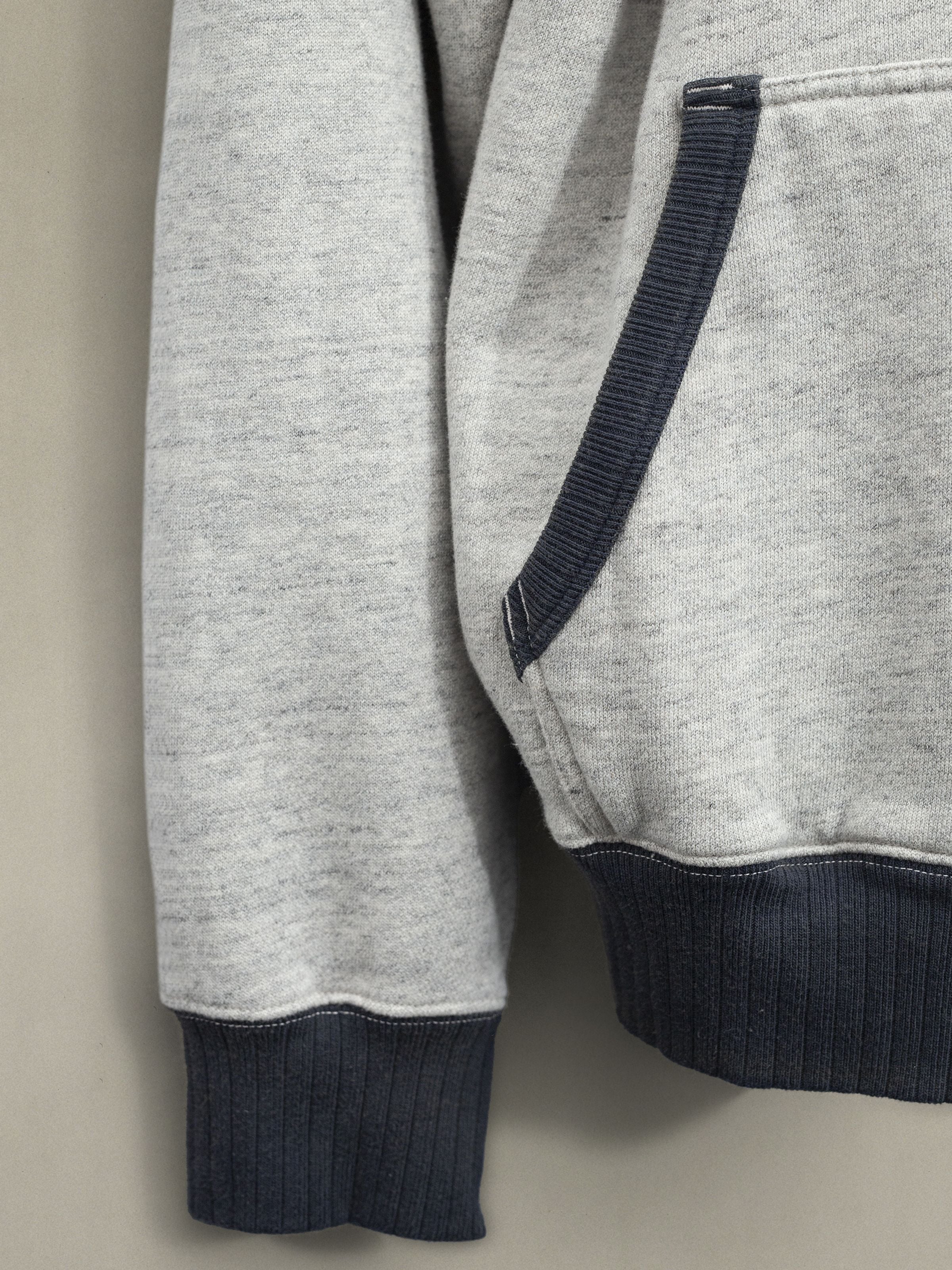 Nudie Jeans Gunde Hoodie Embo Wave Greymelange, detail of the grey organic cotton jersey and contrast navy ribbed trims.