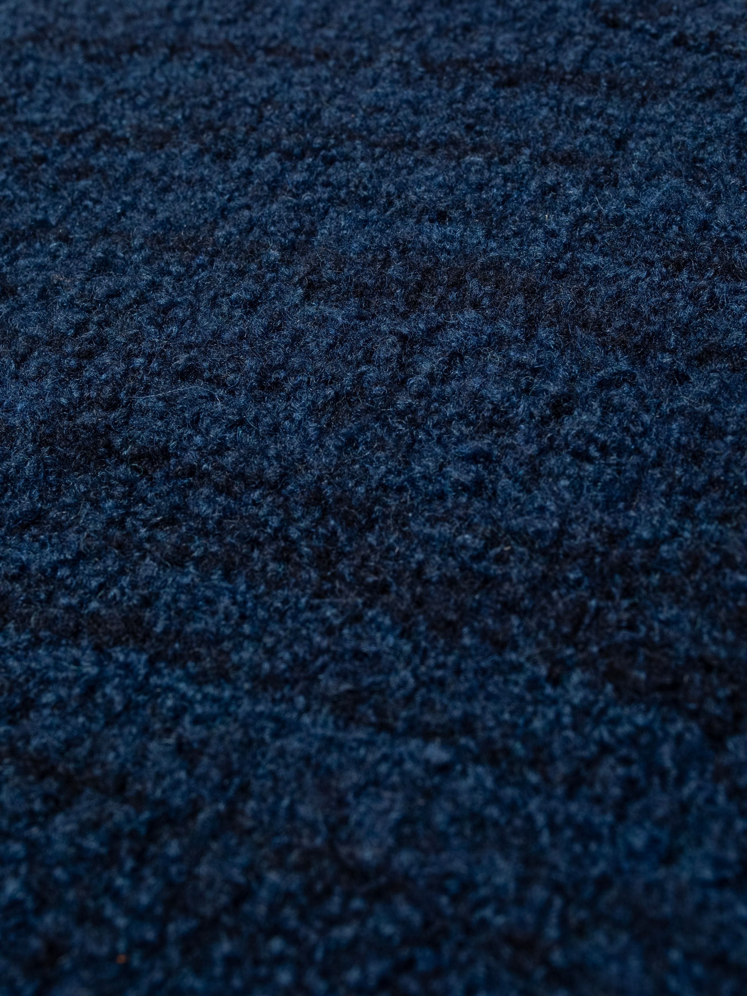 Textured blue organic wool boucle fabric shown in a close-up on the Nudie Jeans Gurra Boucle Sweater Multi.