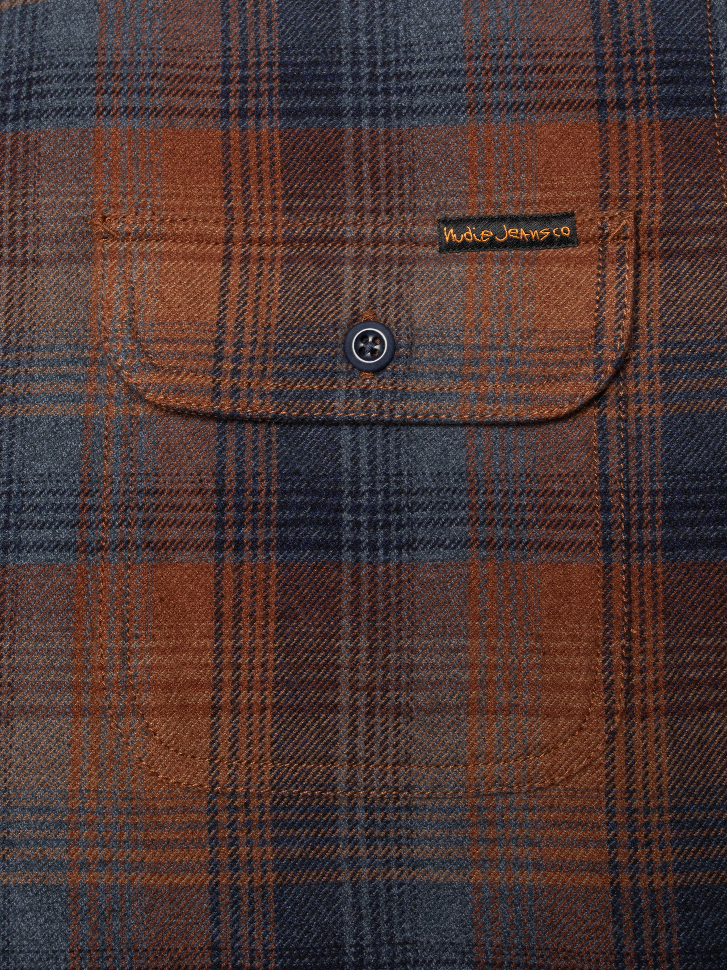 Nudie Jeans Glenn Padded Shirt Check Multi, close-up of the buttoned chest pocket in brown and blue organic cotton.