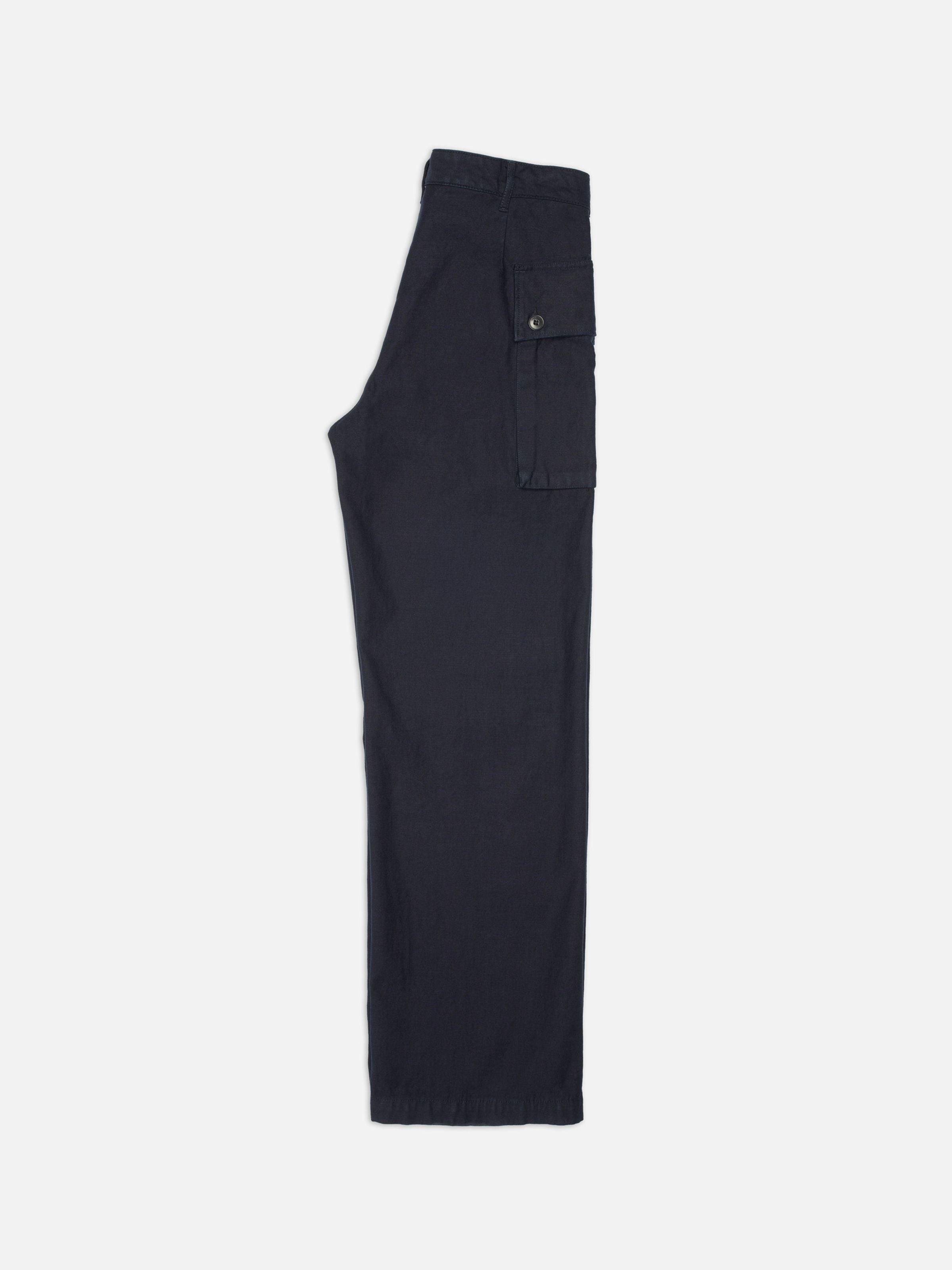 Nudie Jeans Loud Larry Pants Back Sateen in indigo organic cotton, side view showing the wide-leg fit and cargo pocket.