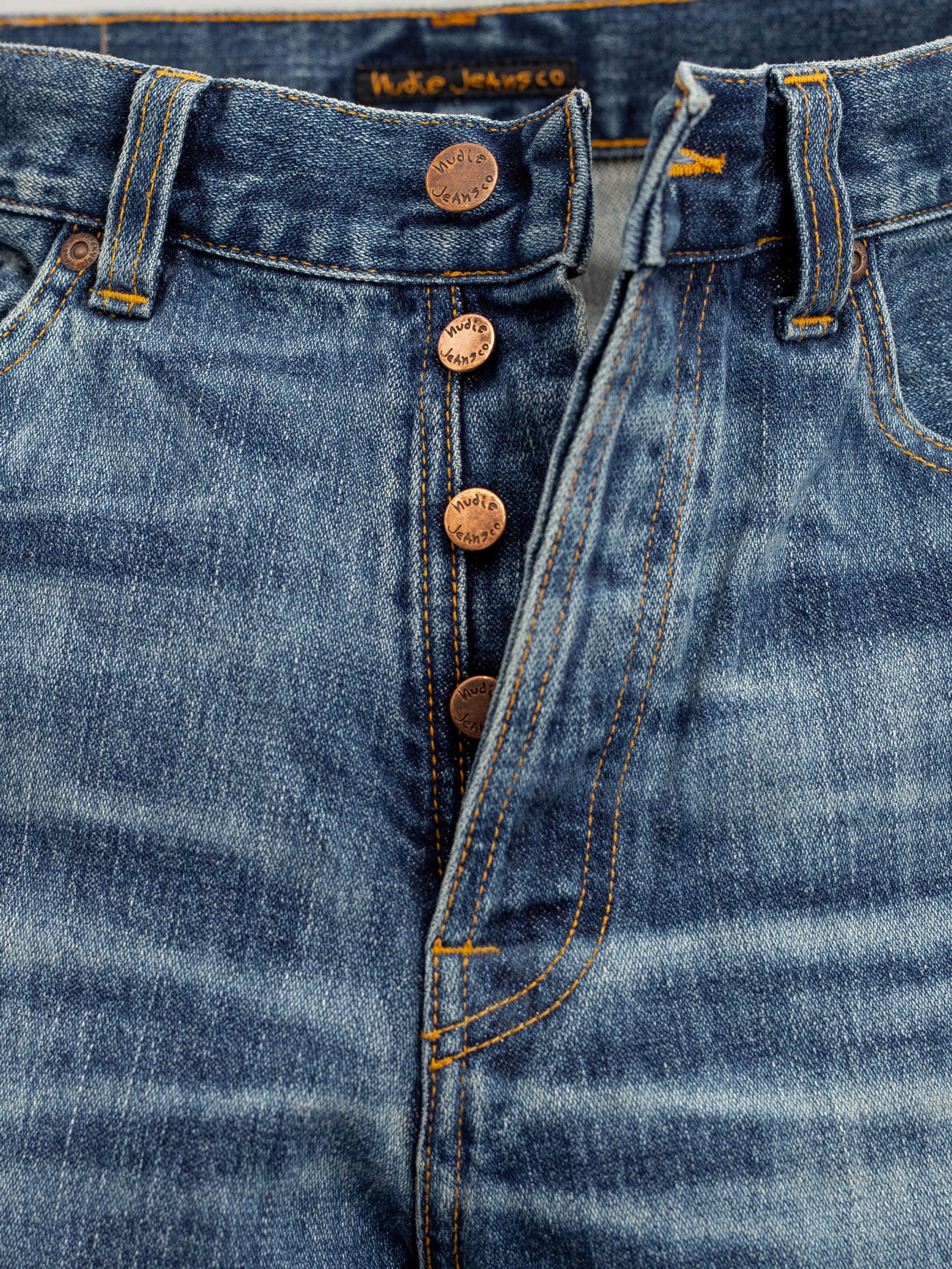 Nudie Jeans Loud Larry Muted Tracks, men's loose fit jeans, showing a close-up of the button fly and copper trims.
