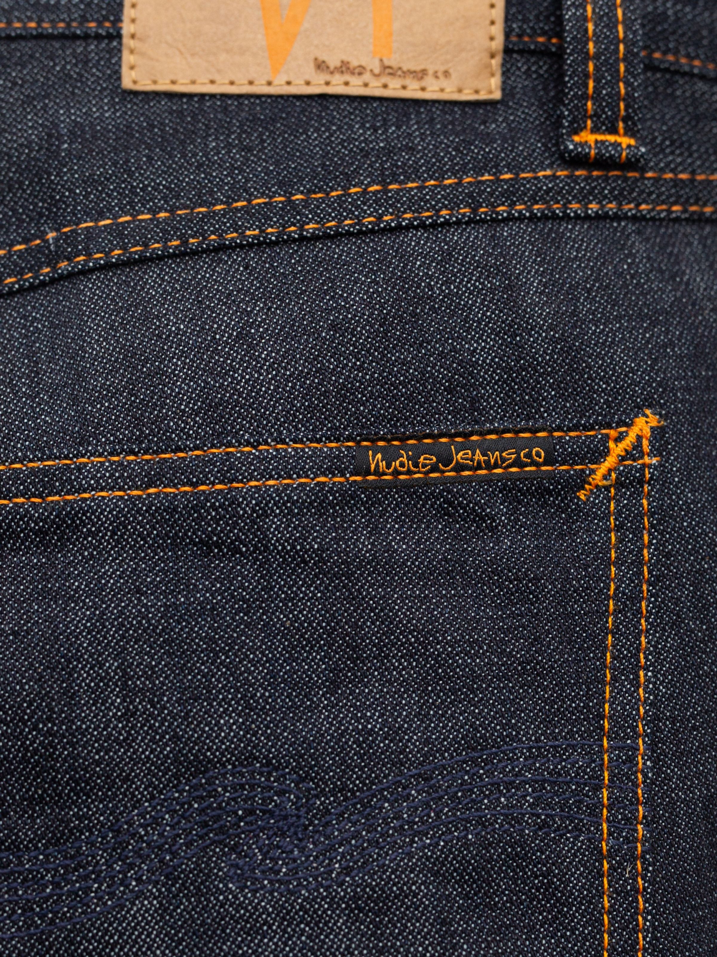 Nudie Jeans Gritty Jackson Blue Dry Two back pocket detail with orange stitching and black label on organic cotton denim.