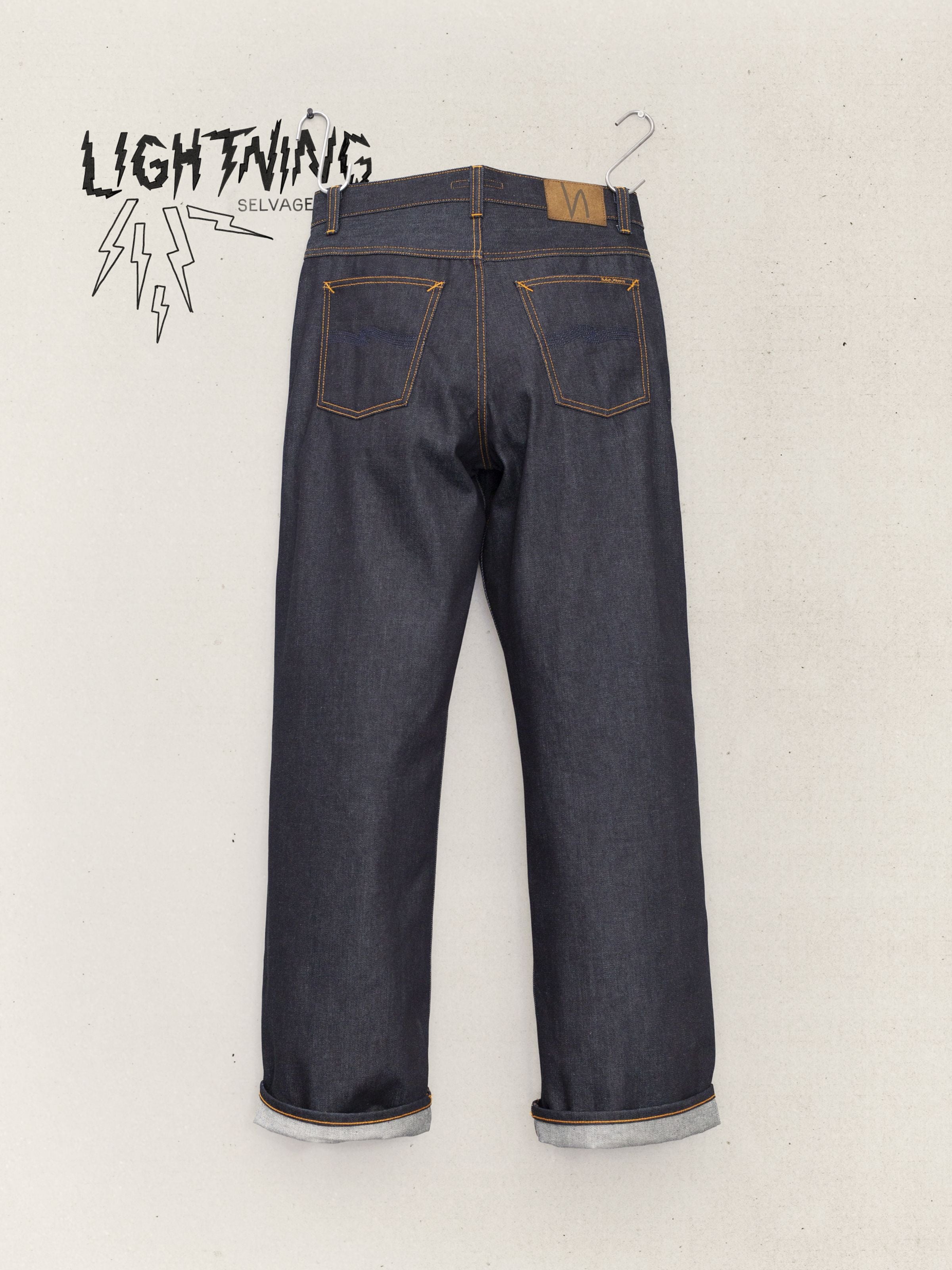 Nudie Jeans Loud Larry Dry Lightning Selv, wide leg organic cotton rigid selvedge jeans in deep indigo, rear view.