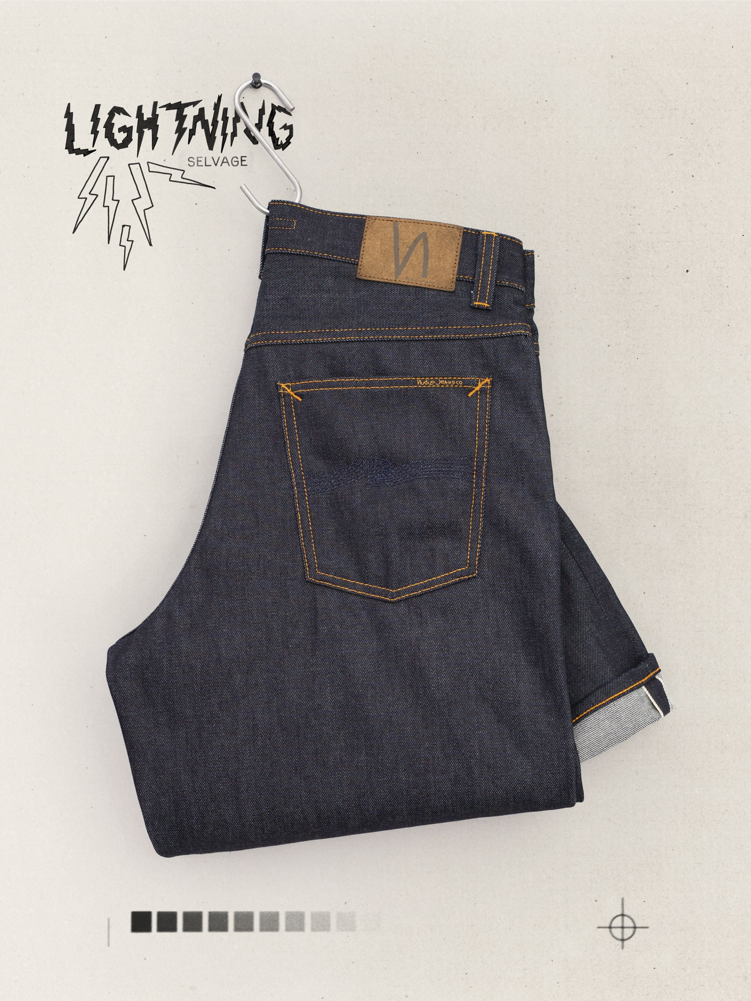 Nudie Jeans Loud Larry Dry Lightning Selv, folded organic cotton rigid selvedge jeans with navy back pocket embroidery.
