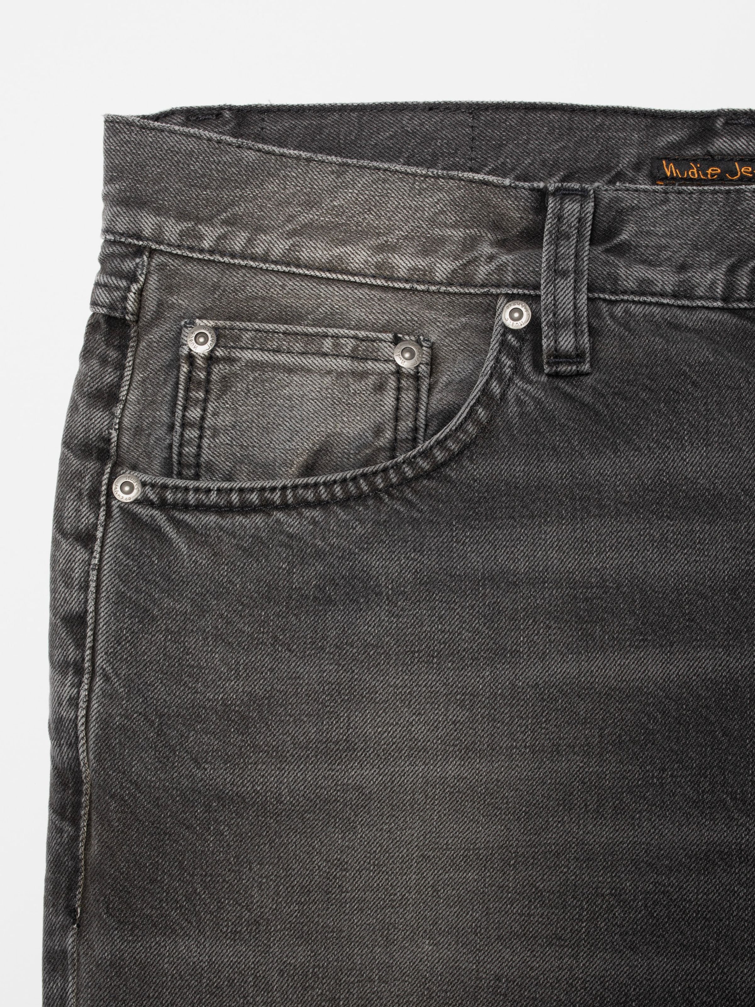 Nudie Jeans Gritty Jackson Grey Lake, close-up of the front pocket and silver rivets on grey organic cotton denim.