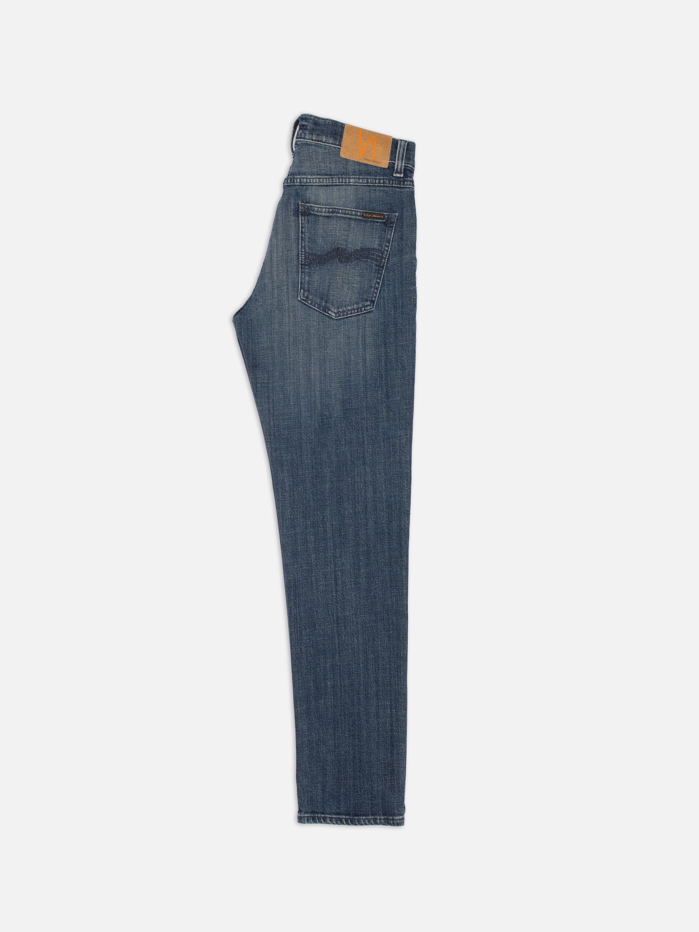 Nudie Jeans Solid Ollie Epic Ink slim straight jeans in dark blue organic cotton, shown from a side profile view.