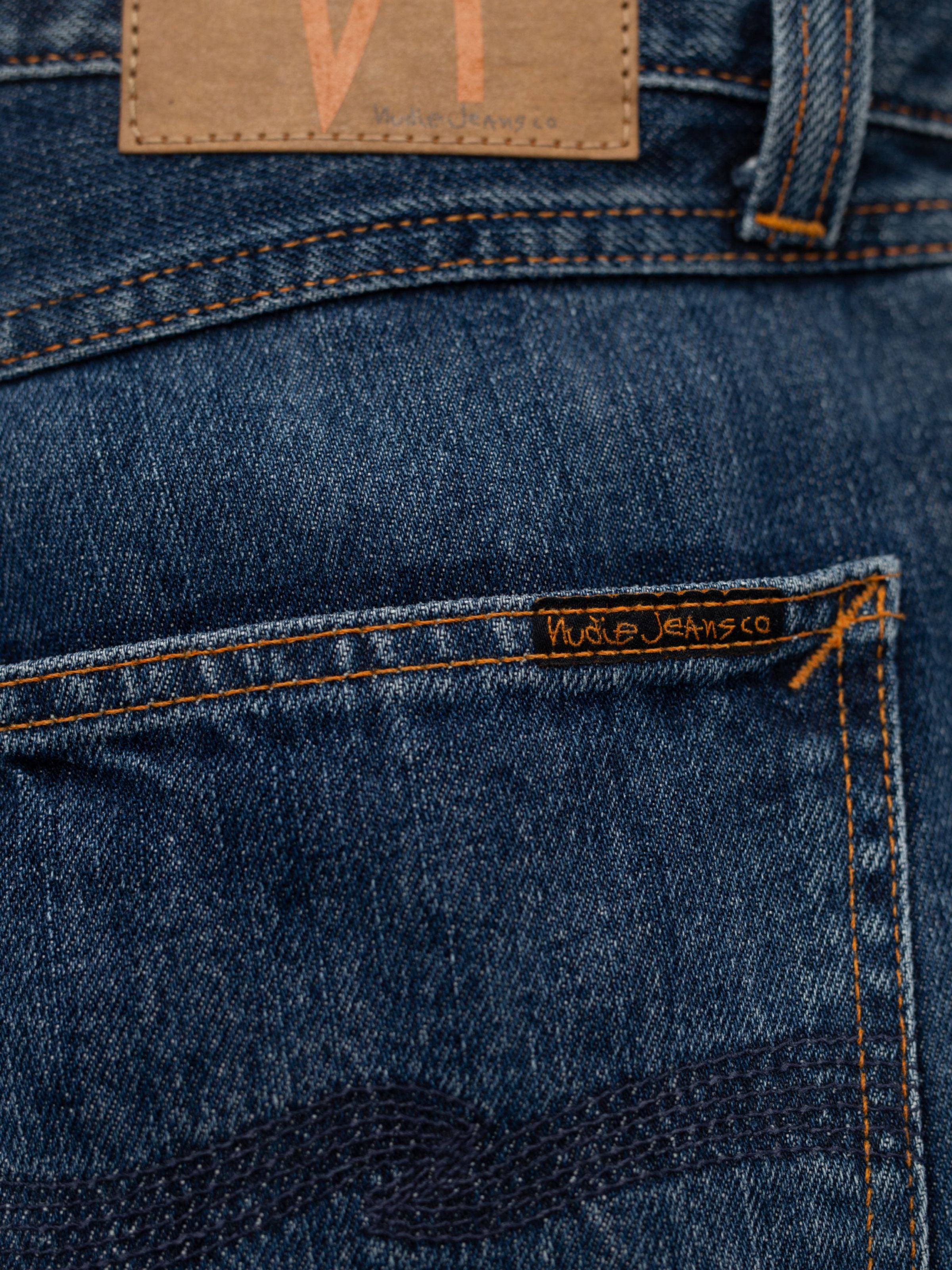 Nudie Jeans Rad Rufus Blue Twisted Tracks, a close-up of the back pocket in washed indigo rigid organic cotton denim.