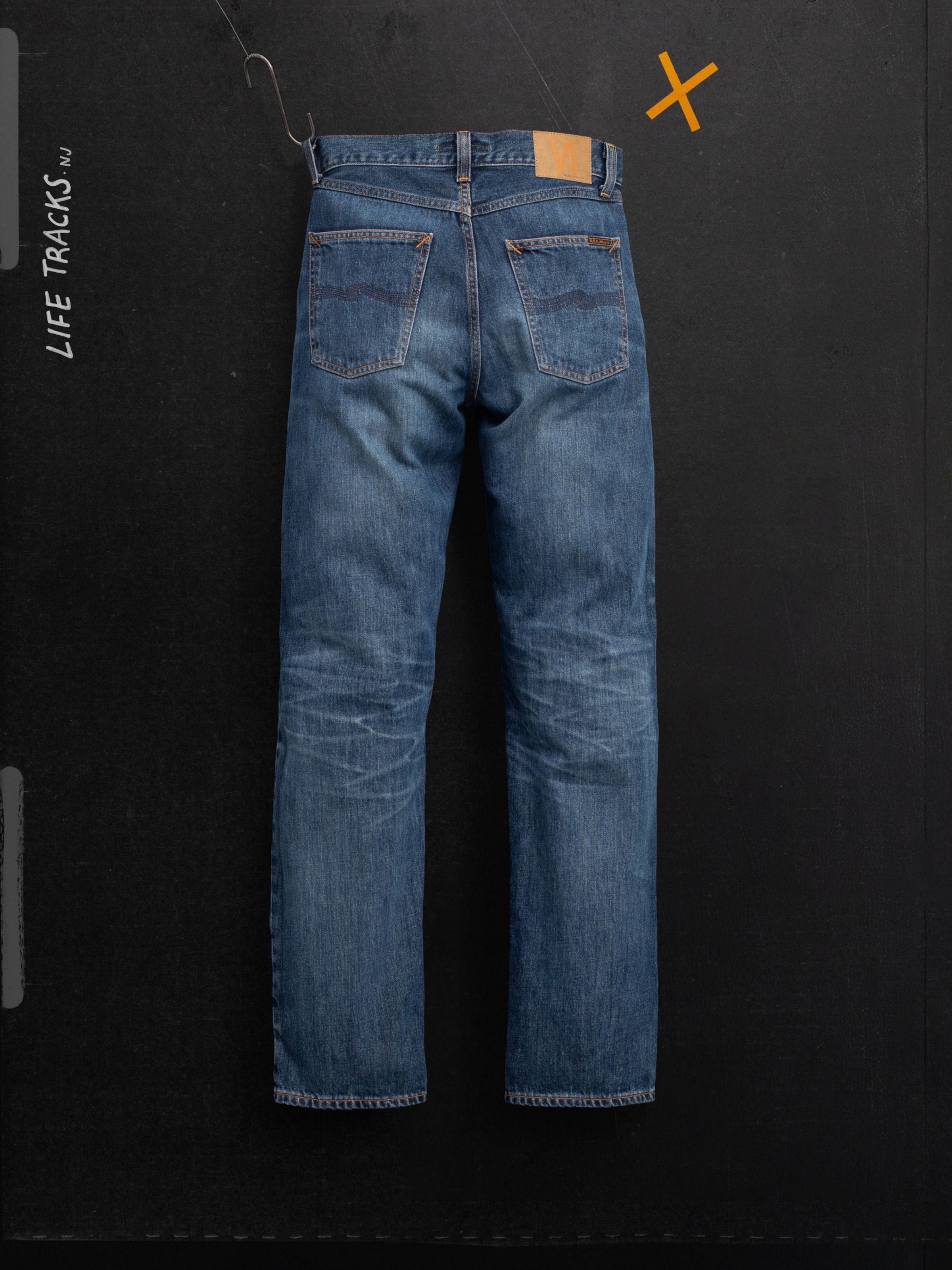 Nudie Jeans Rad Rufus Blue Twisted Tracks, back view of regular fit organic cotton jeans in a worn-in indigo wash.