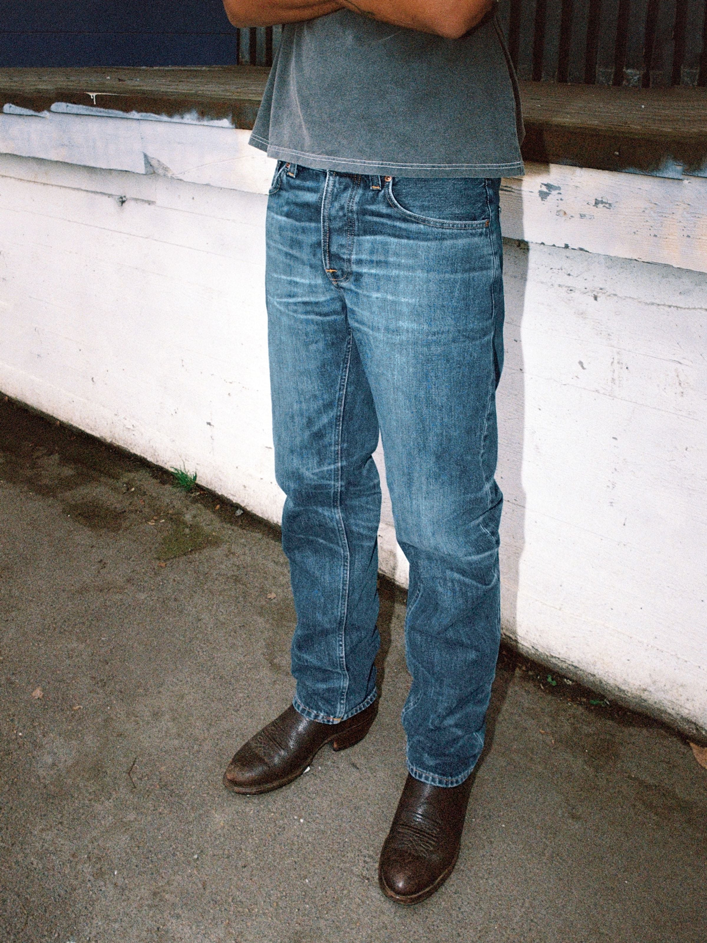 Nudie Jeans Rad Rufus Blue Twisted Tracks, regular fit straight leg organic cotton jeans with a worn-in wash on a model.
