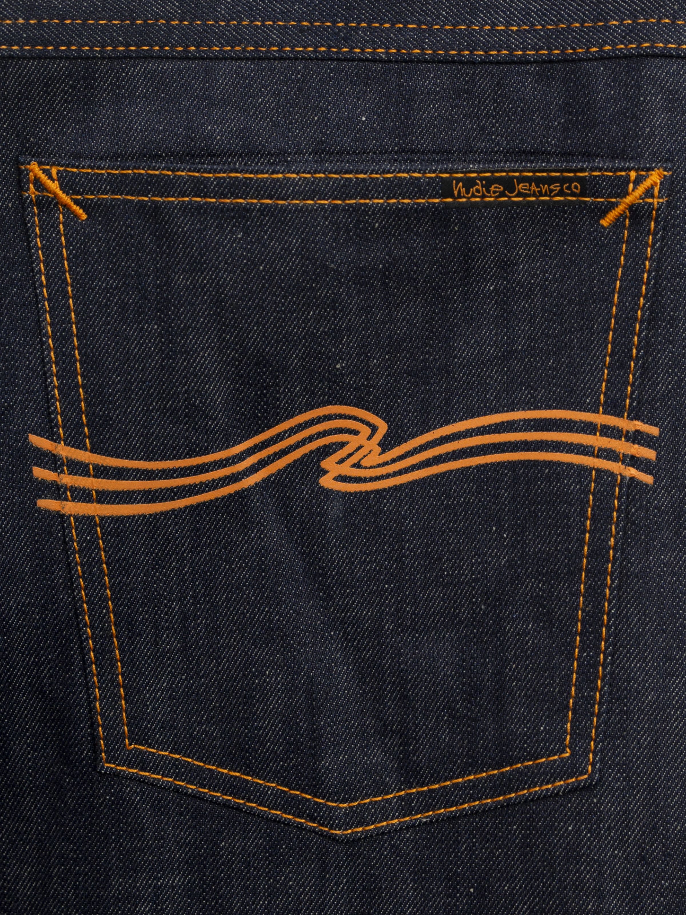 Nudie Jeans Dusty Dee Dry Weird back pocket, featuring the orange printed embroidery on dark indigo rigid denim.