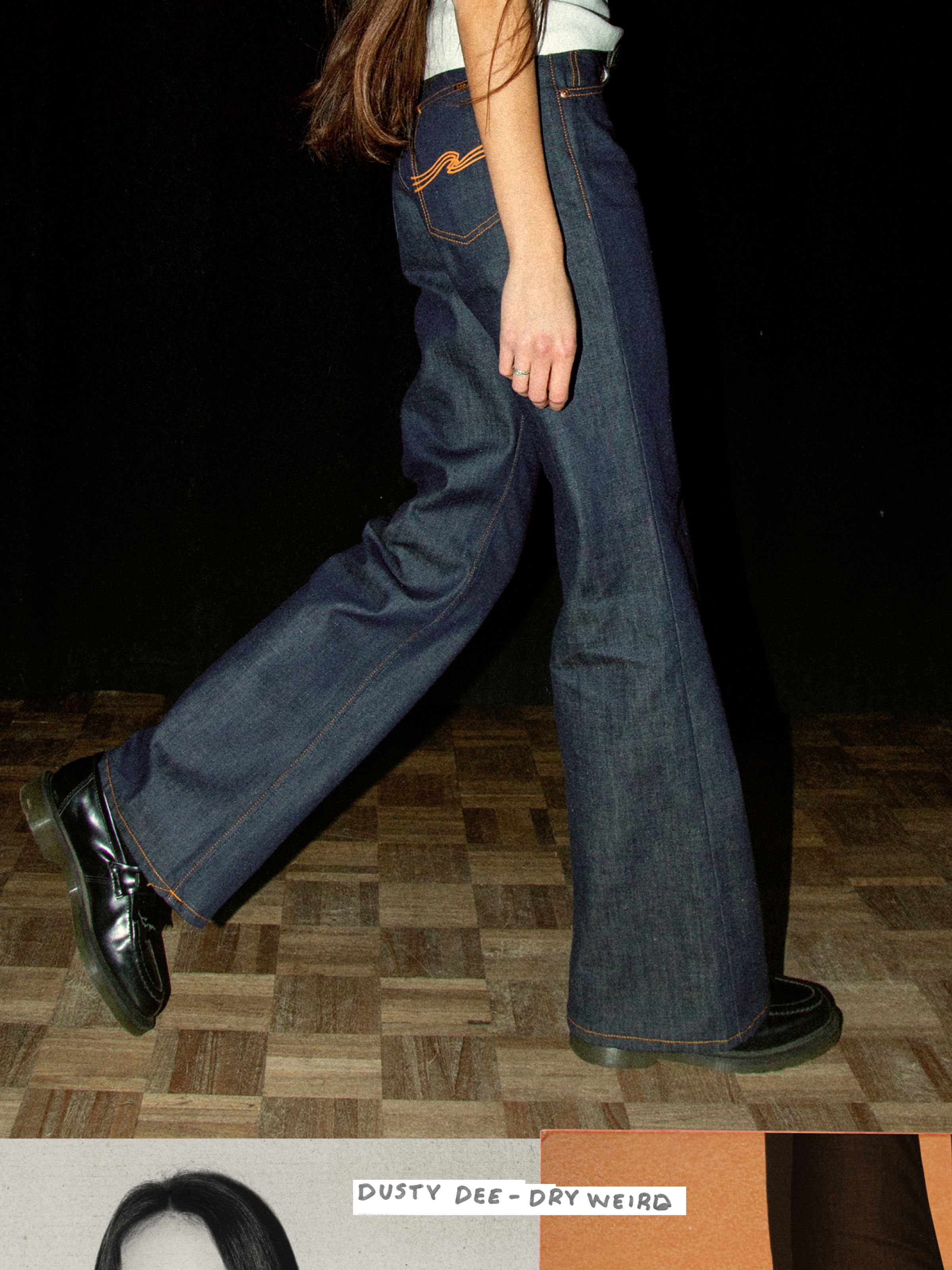 Nudie Jeans Dusty Dee Dry Weird, women's flared leg jeans in dark indigo shown on a model walking from the waist down.