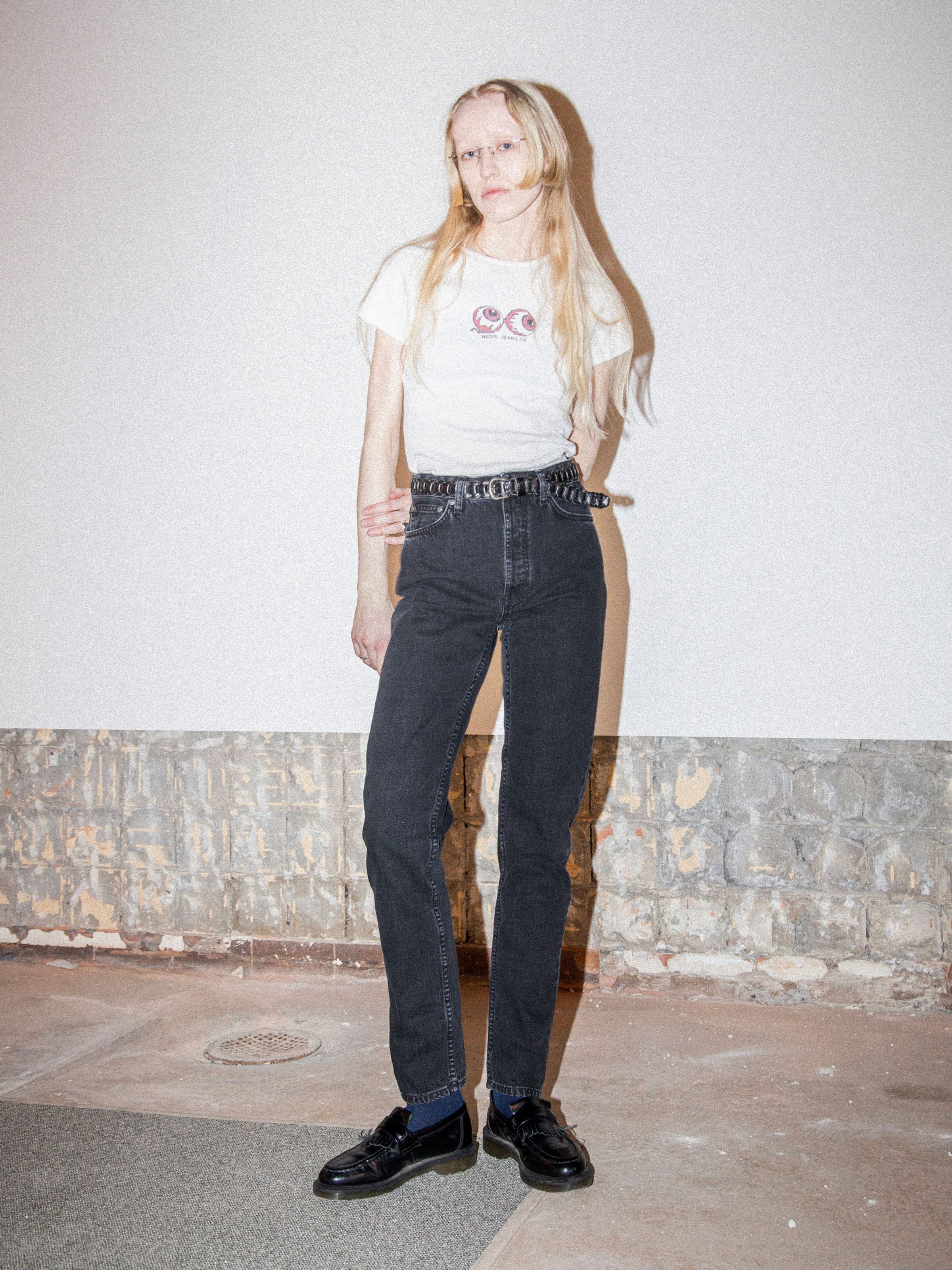 Nudie Jeans Breezy Britt Friendly Black, women's high-waisted regular fit organic cotton jeans shown on a model.