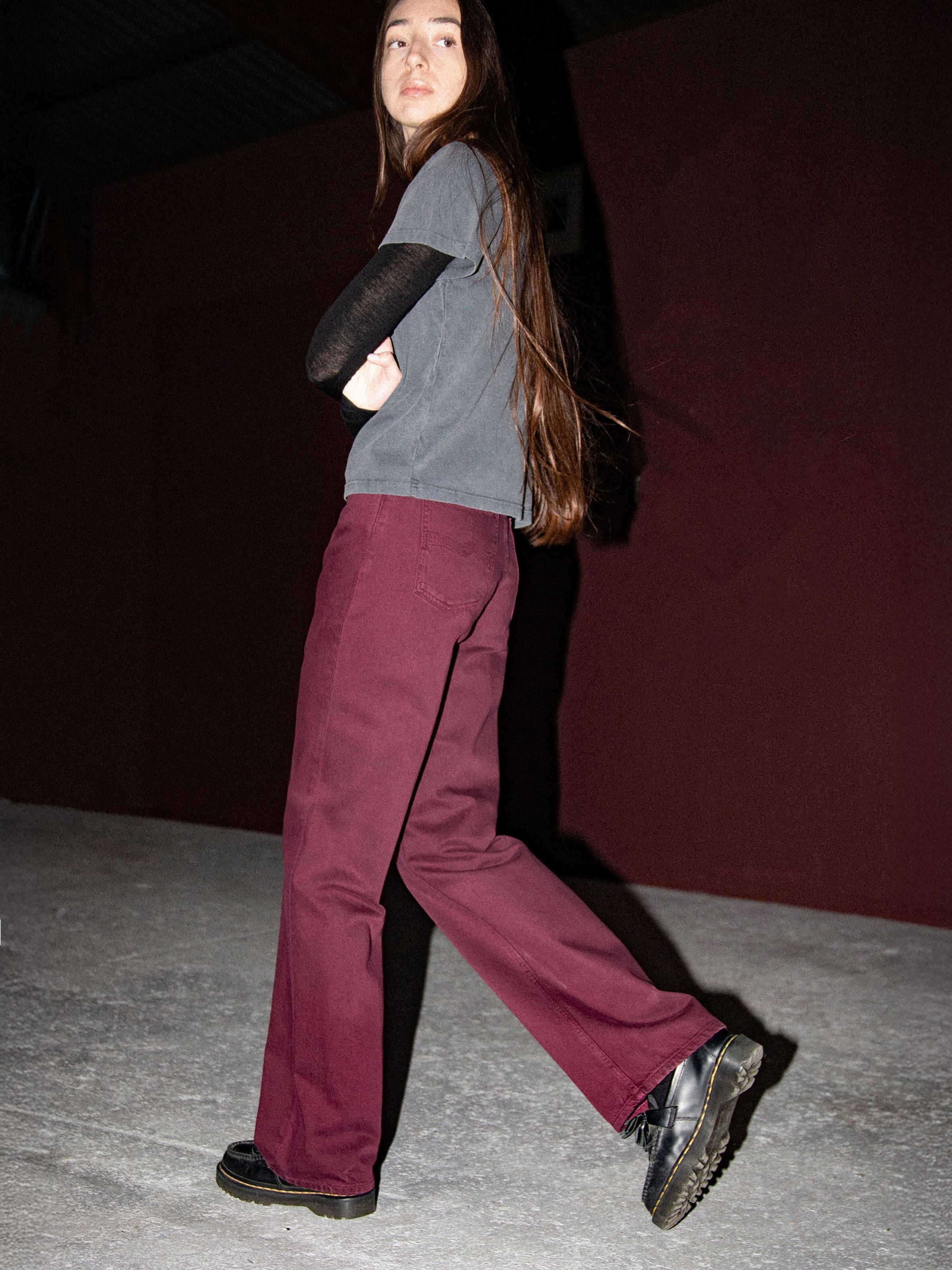 Nudie Jeans Clean Eileen Burgundy, women's wide leg rigid organic cotton jeans shown from the side on a model walking.