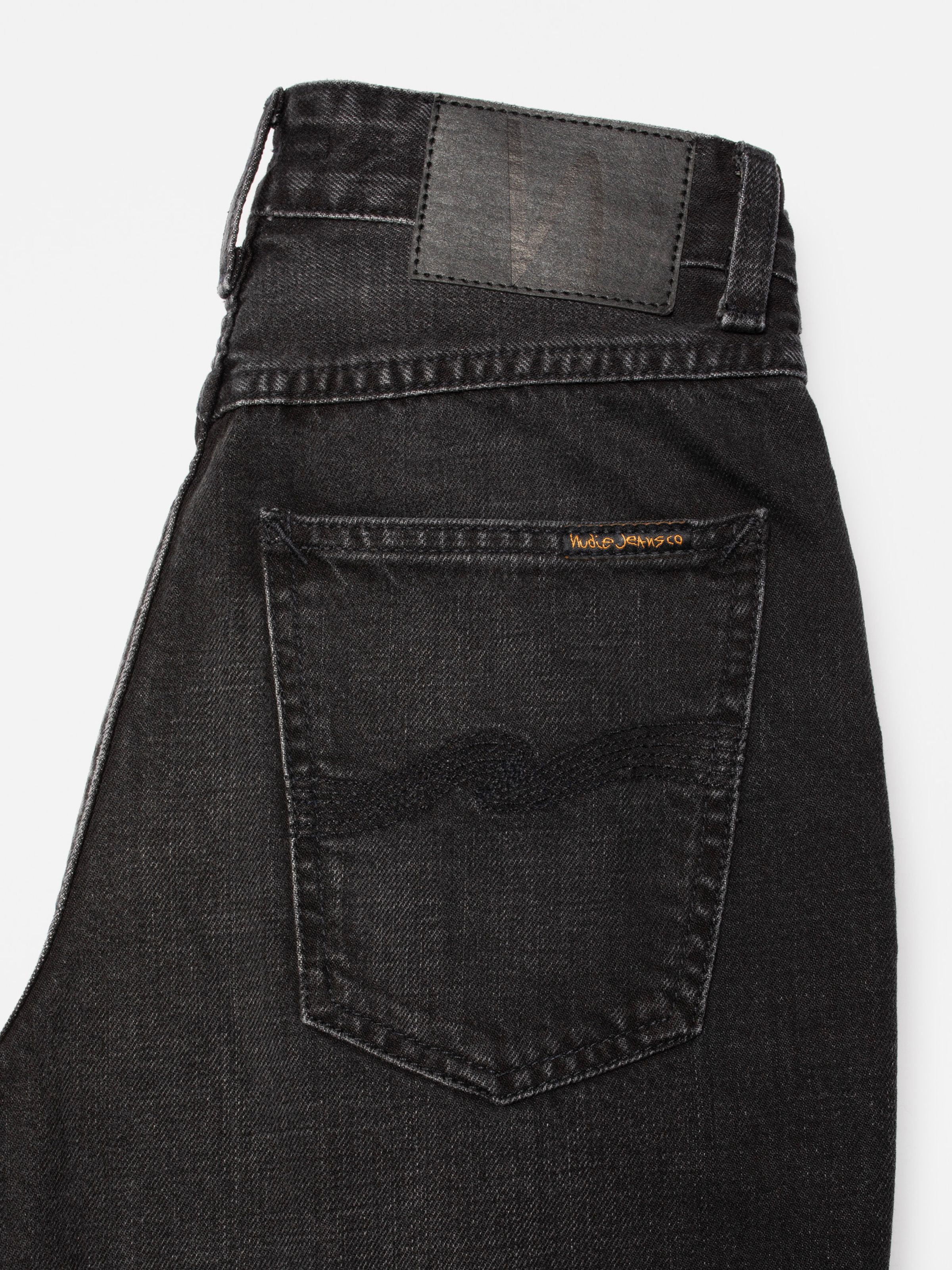 Nudie Jeans Clean Eileen Night Dune, close-up of the back pocket and Jacron patch on black organic cotton rigid denim.