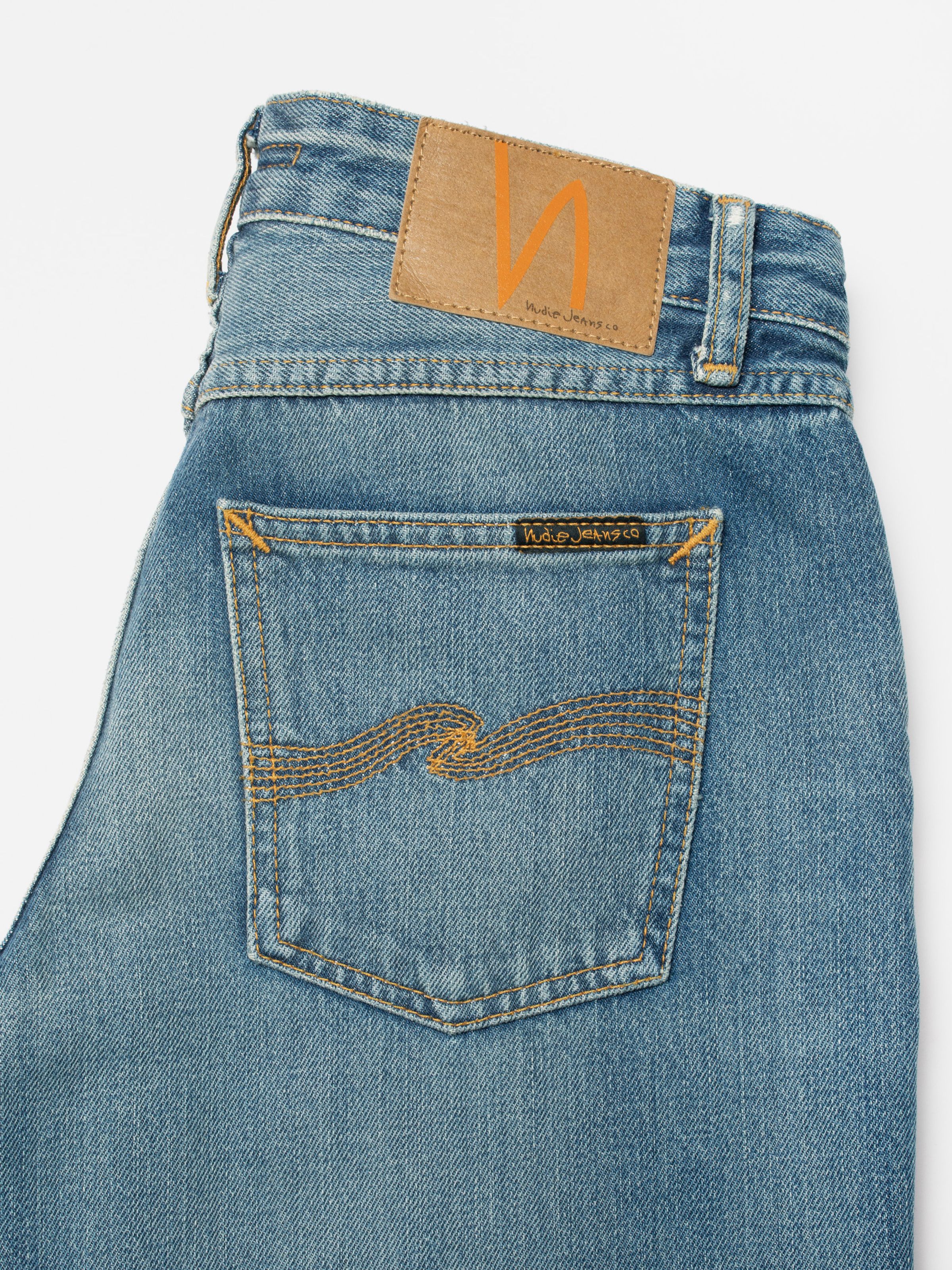 Nudie Jeans Wide Heidi Gravel Stone, close-up of the back pocket and Jacron patch on organic cotton mid-blue denim.