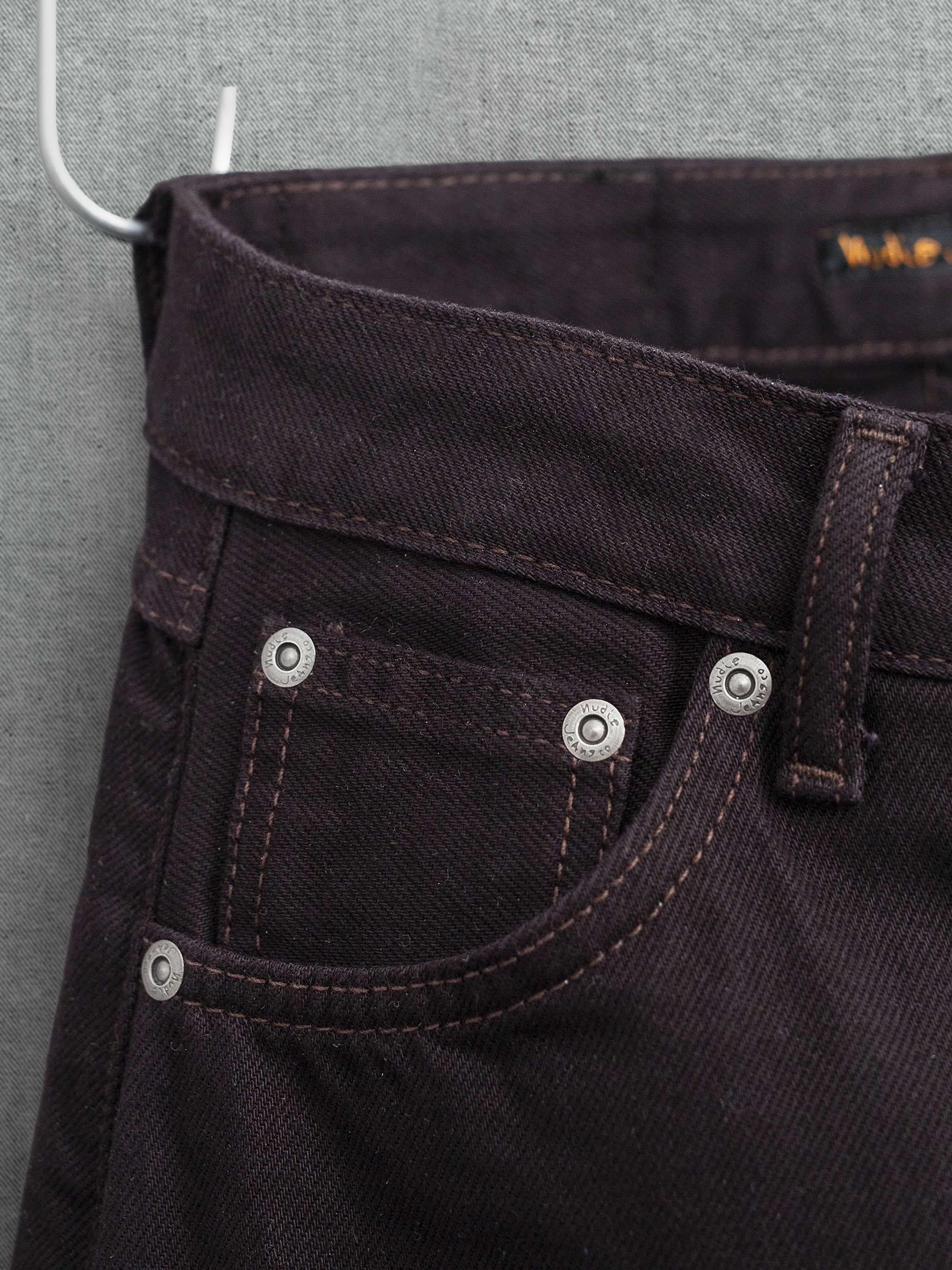 Nudie Jeans Sonic Sue Everbrown, front pocket detail in deep brown organic cotton rigid denim with silver rivets.