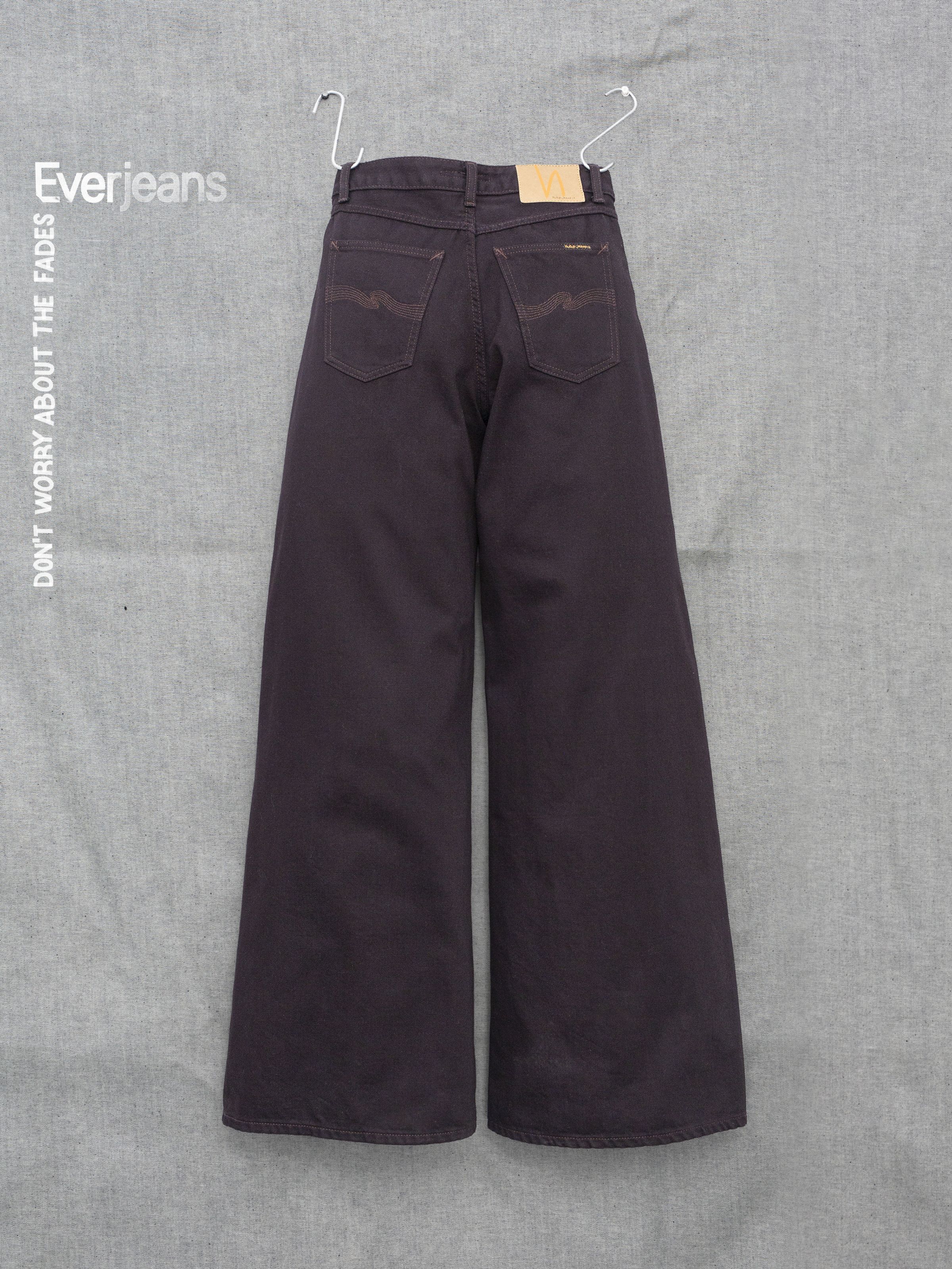 Nudie Jeans Sonic Sue Everbrown, women's wide-leg jeans in deep brown organic cotton rigid denim, shown from the back.