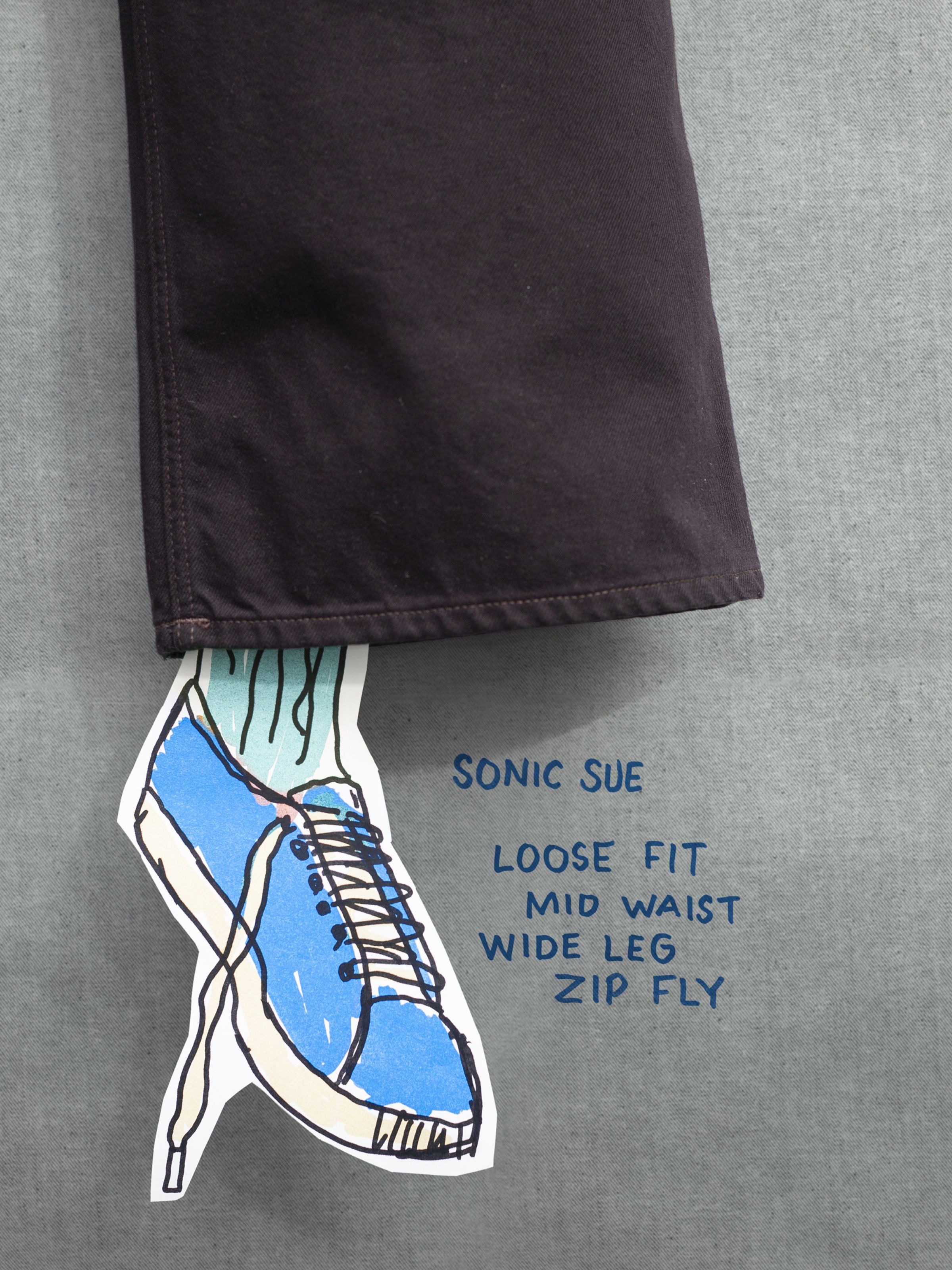 Nudie Jeans Sonic Sue Everbrown, a close-up of the wide leg hem on deep brown rigid organic cotton denim with fit info.
