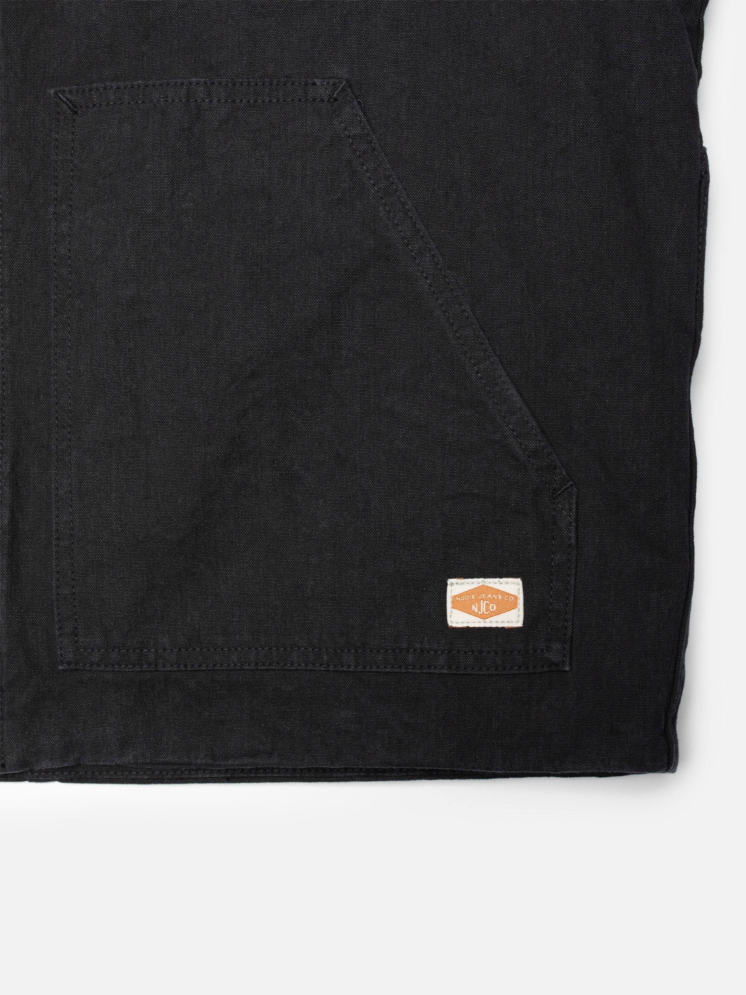 Nudie Jeans Lana Jacket Duck Canvas Black, close-up of the organic cotton duck canvas and patch pocket with logo tag.